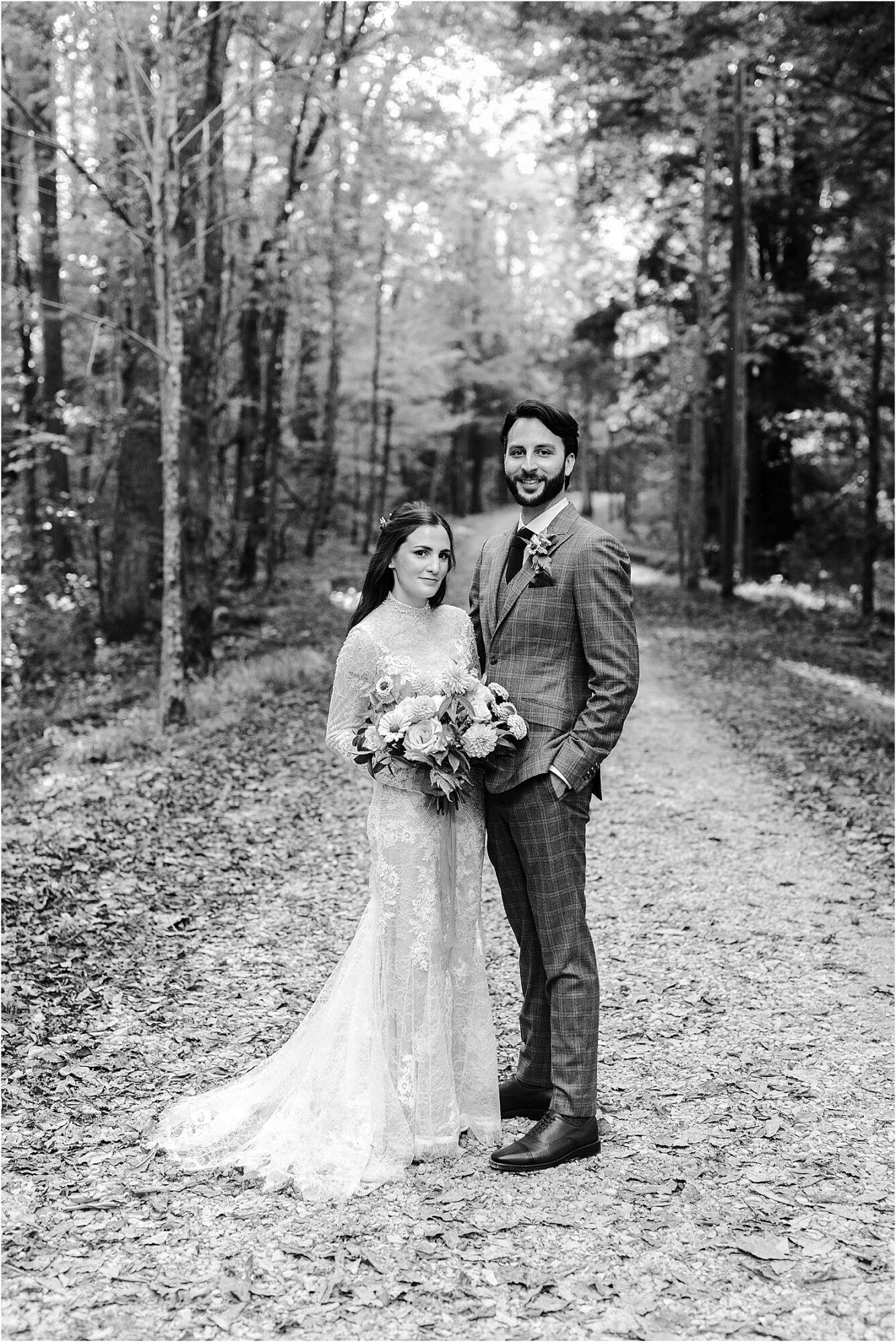 black and white portrait on bride and groom standing on Little River Trail in Elkmont