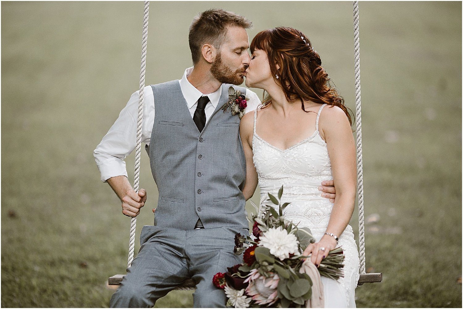 Bride and Groom kissing on swing on wedding day