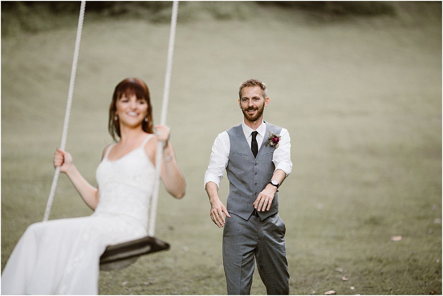 Groom pushing bride on swing on wedding day