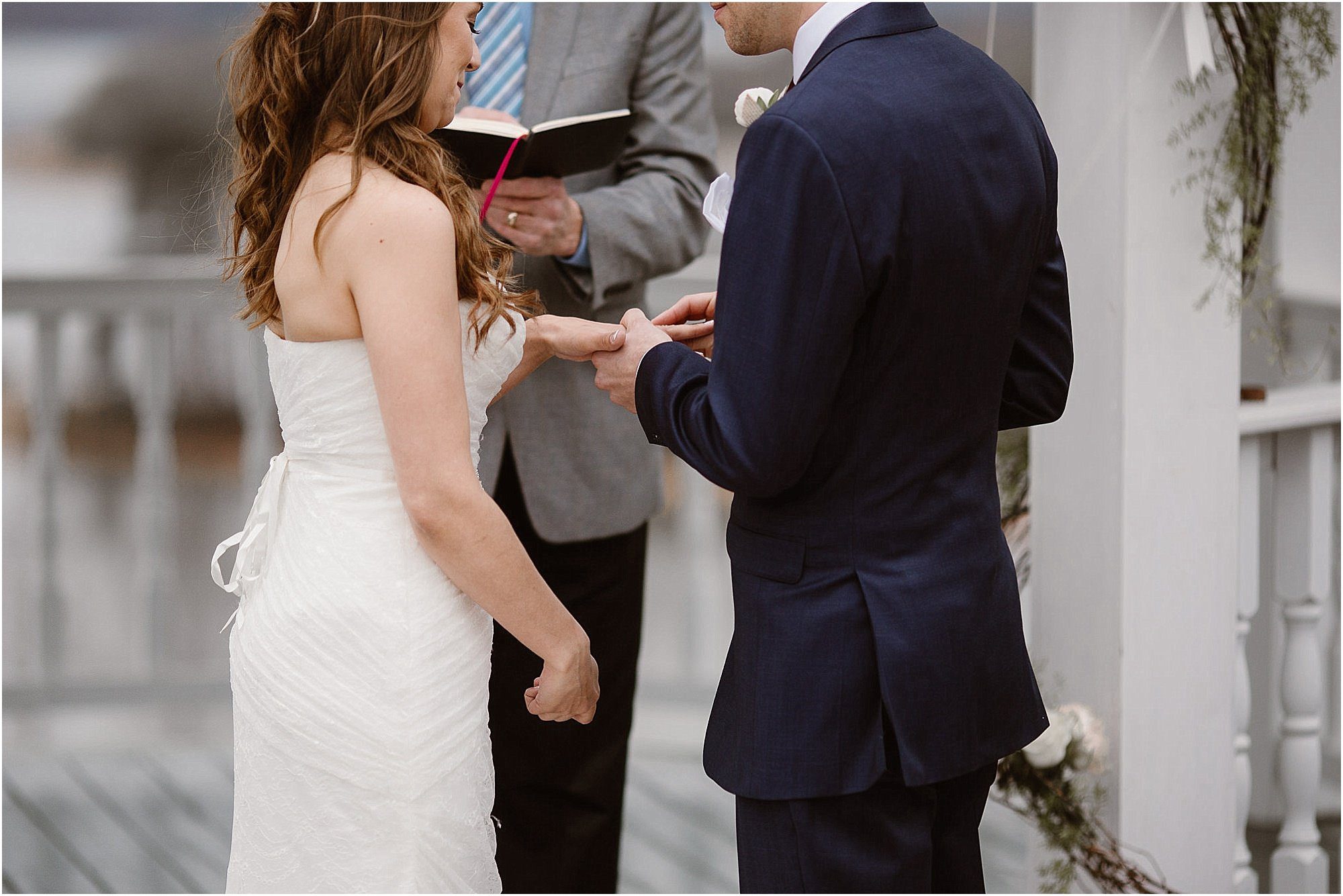 Groom putting ring on brides finger at Whitestone Inn Wedding