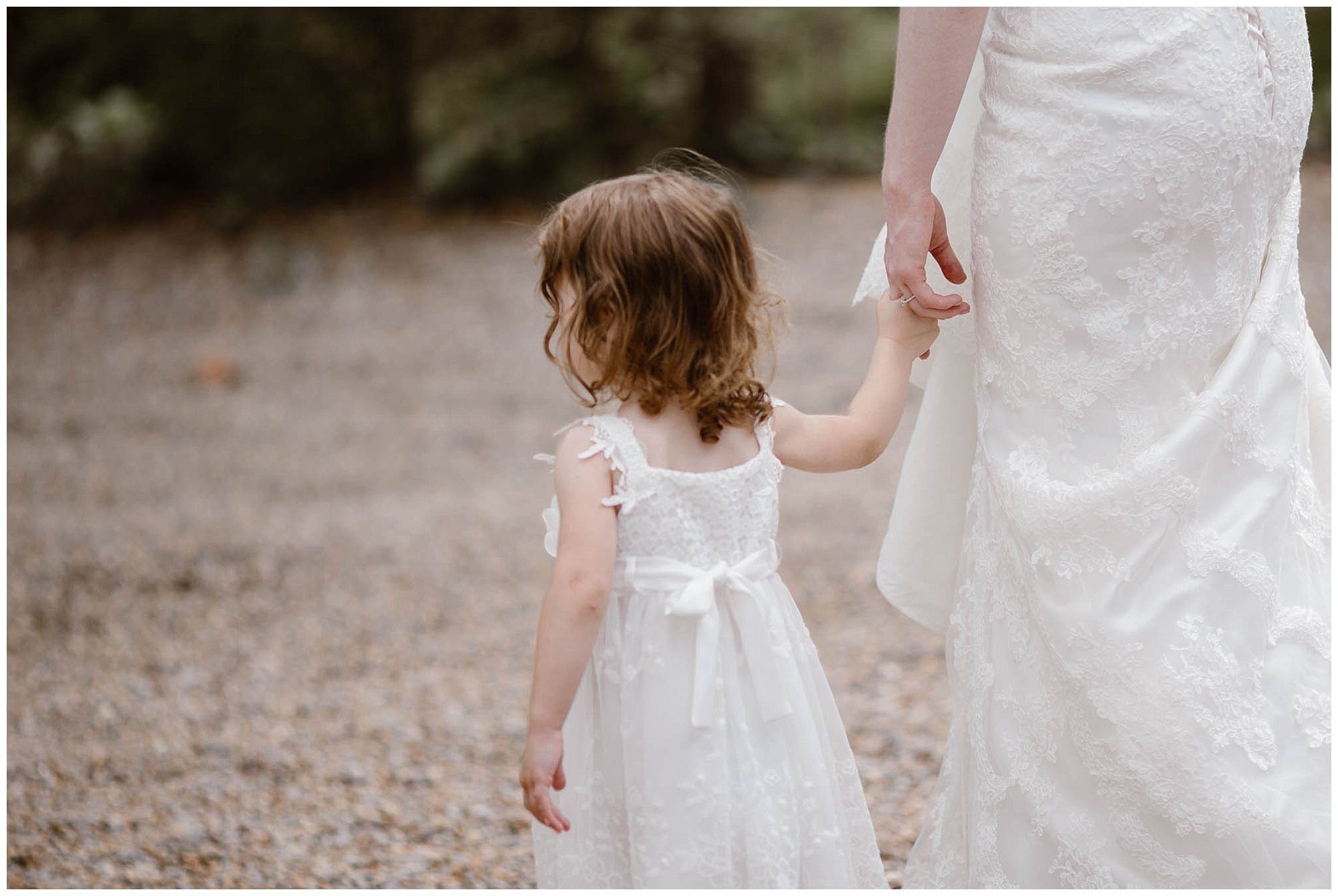 Bride holding flower girl's hand at Crescent Bend House Knoxville