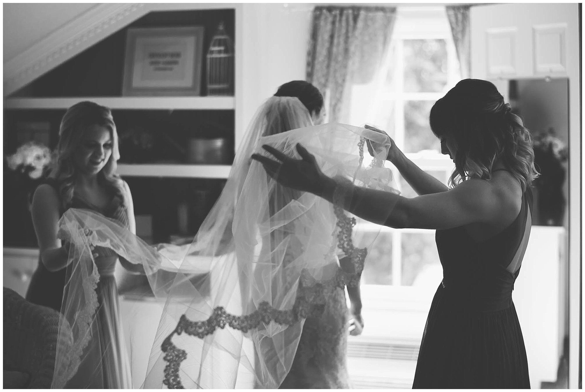 Bride putting on veil at Crescent Bend House Wedding Knoxville