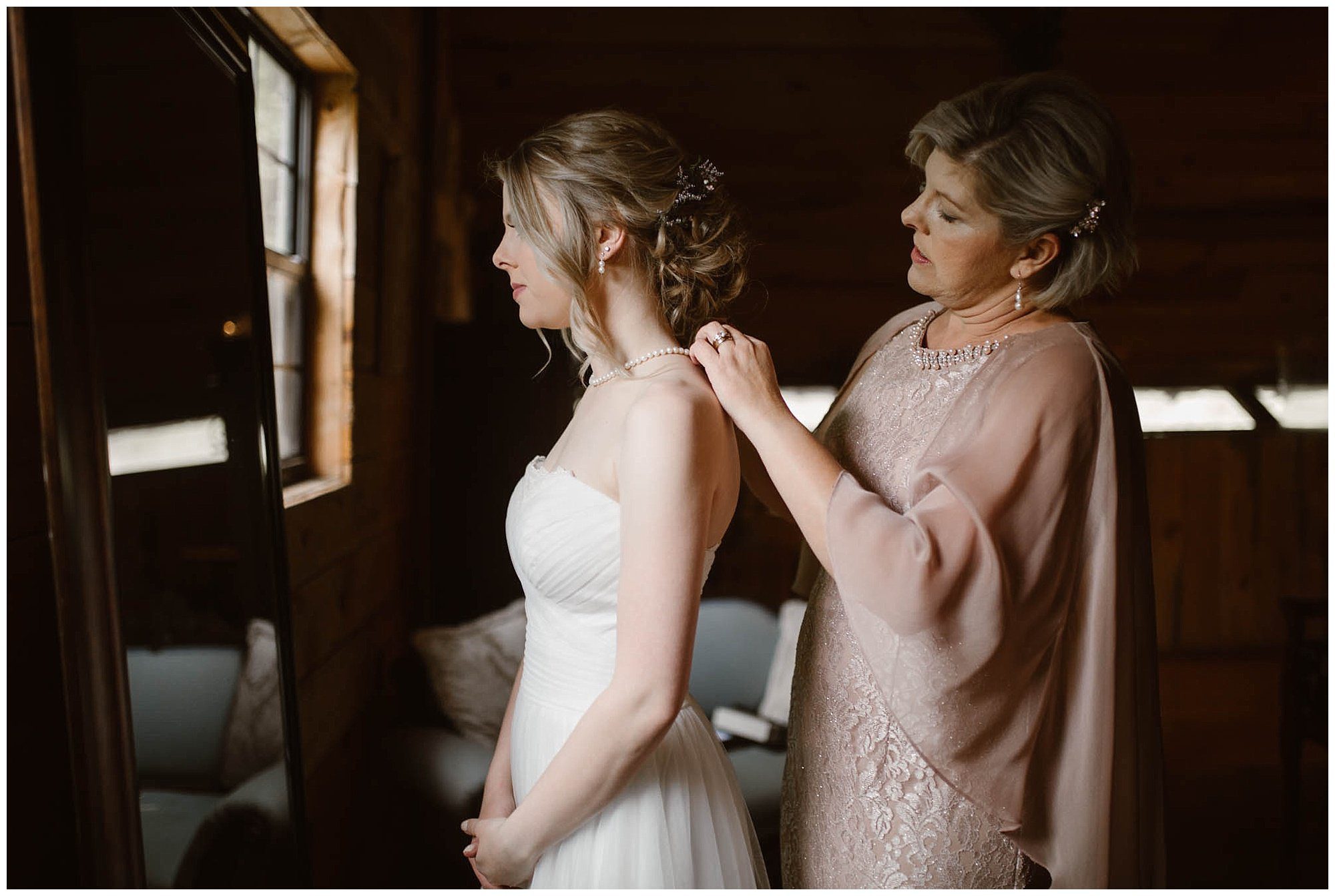 Mother of the bride helping bride get ready