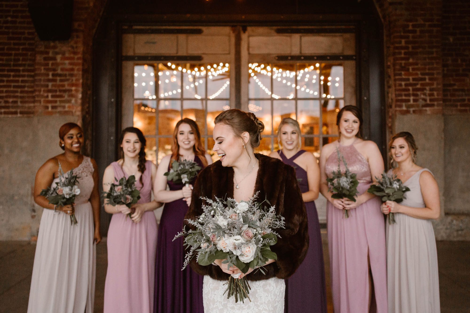 bride standing in front of bridesmaids at Mill and Mine Wedding Venue in Knoxville
