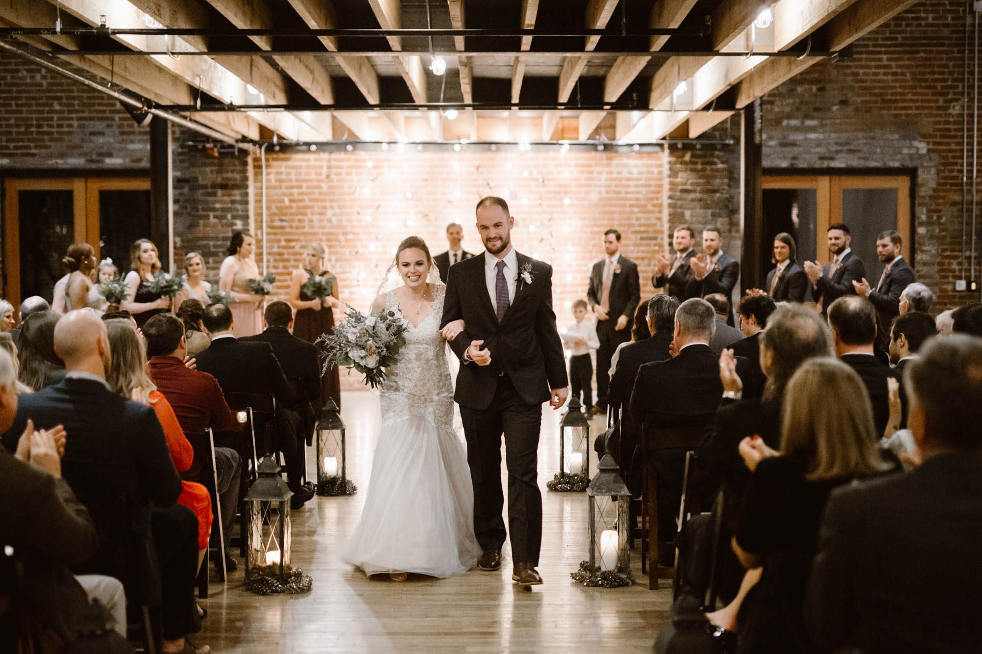 bride and groom walking down aisle at Mill and Mine Wedding Venue in Knoxville