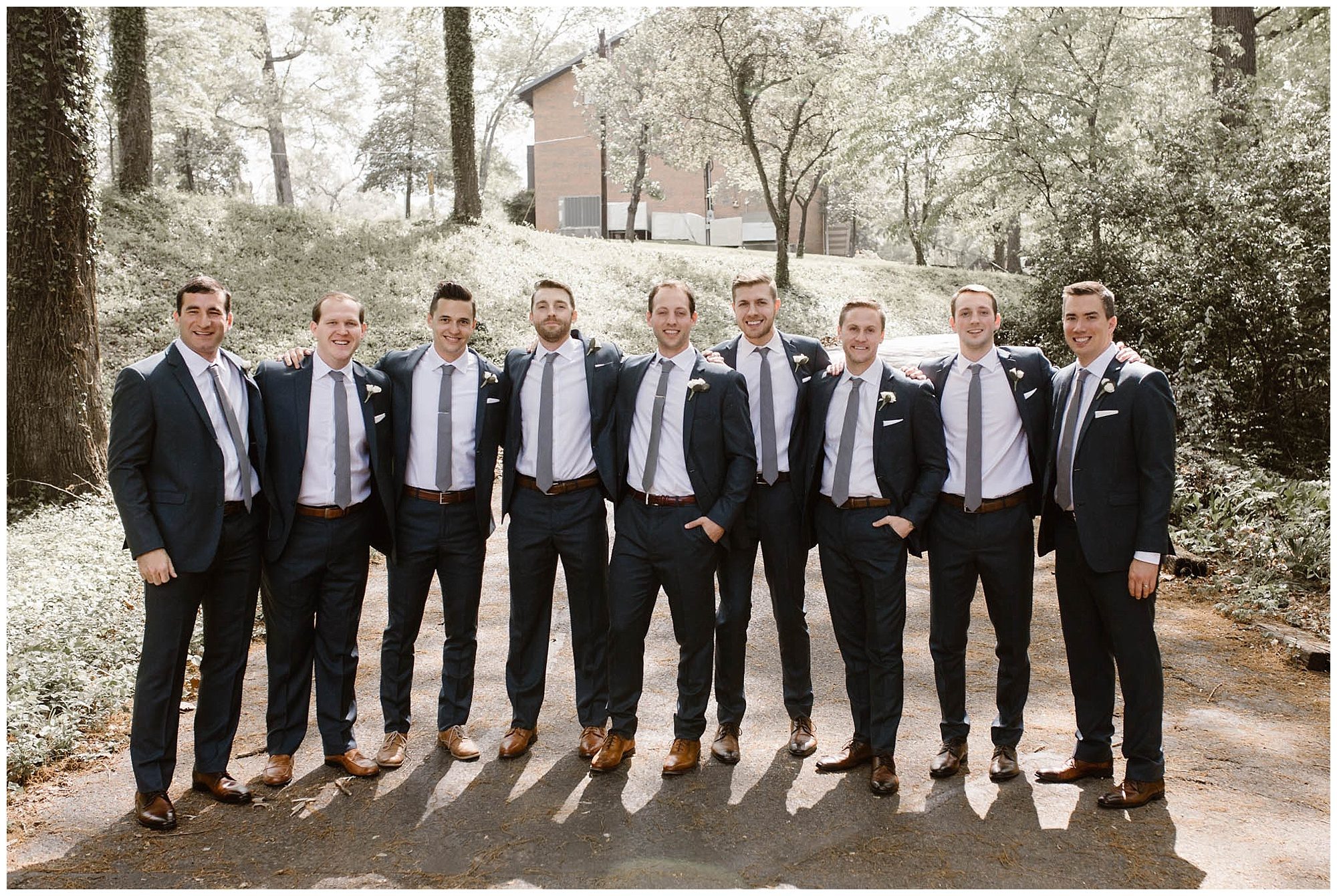 groom and groomsmen standing next to each other