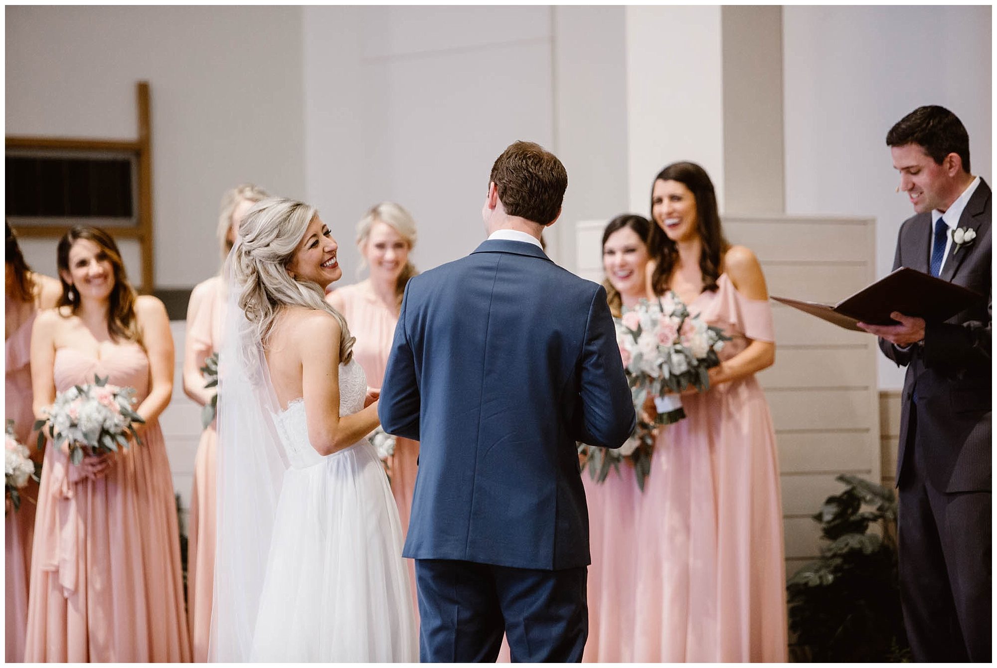 bride laughing at groom during wedding ceremony