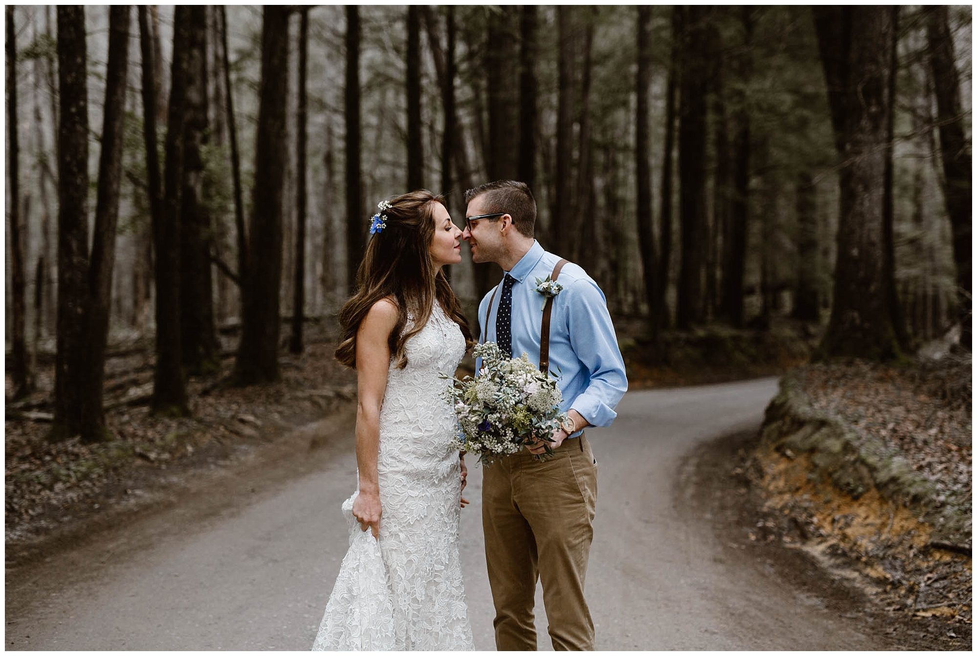 bride and groom kissing on gravel road in the Smokies