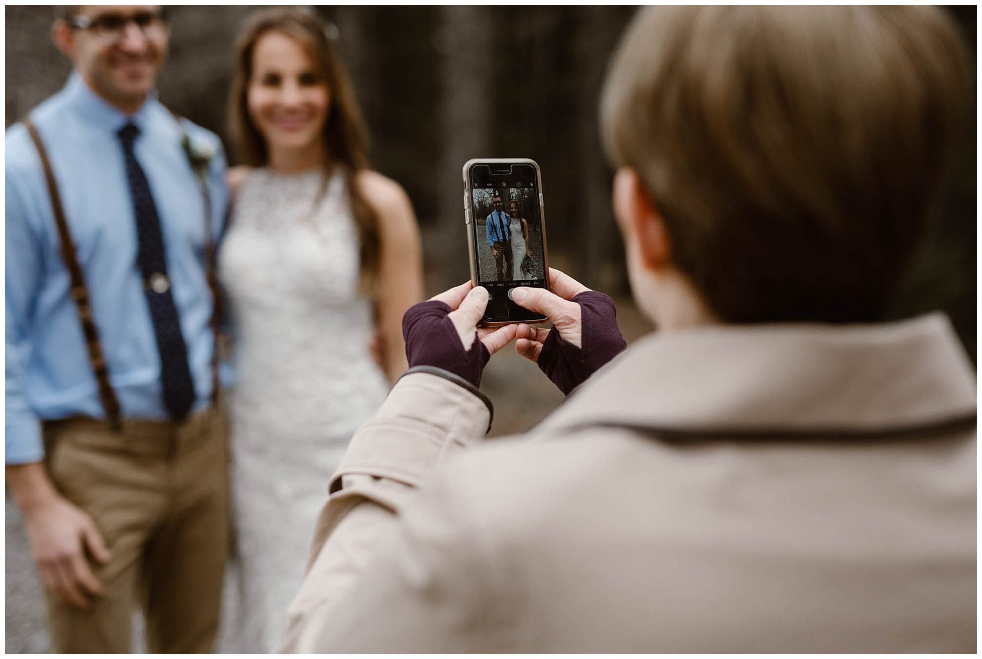 person taking a photo of a bride and a groom