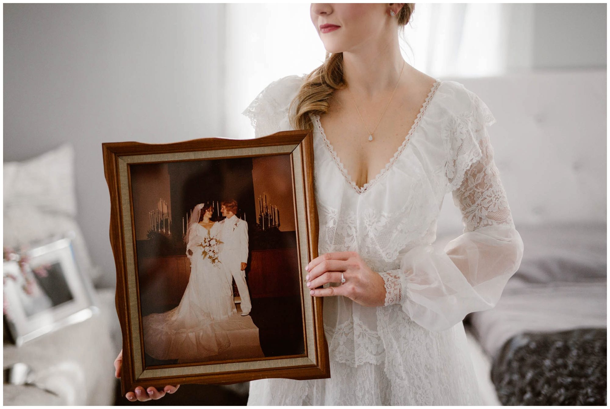 bride holding portrait of her mother on wedding day