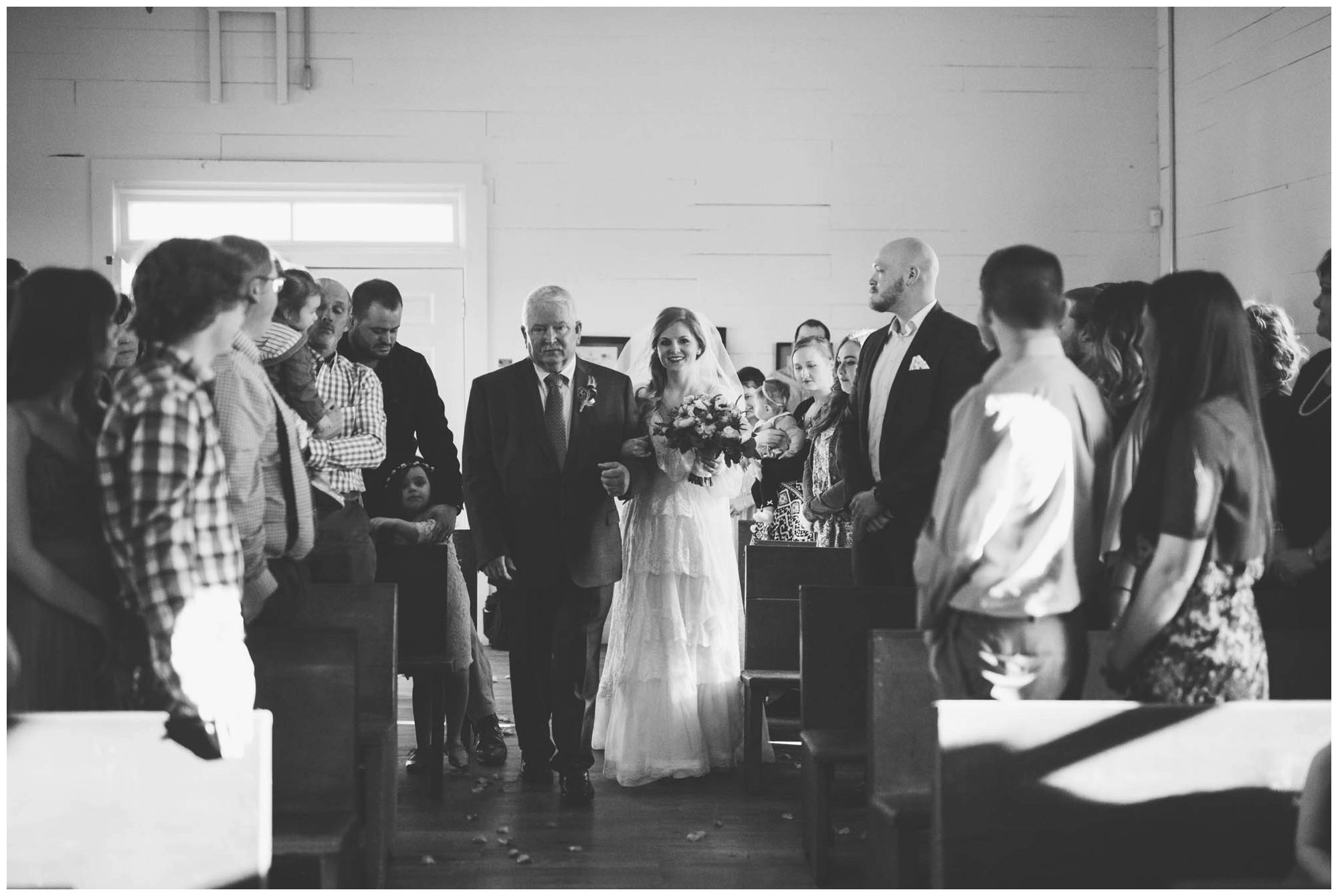 bride walking down aisle with father on wedding day