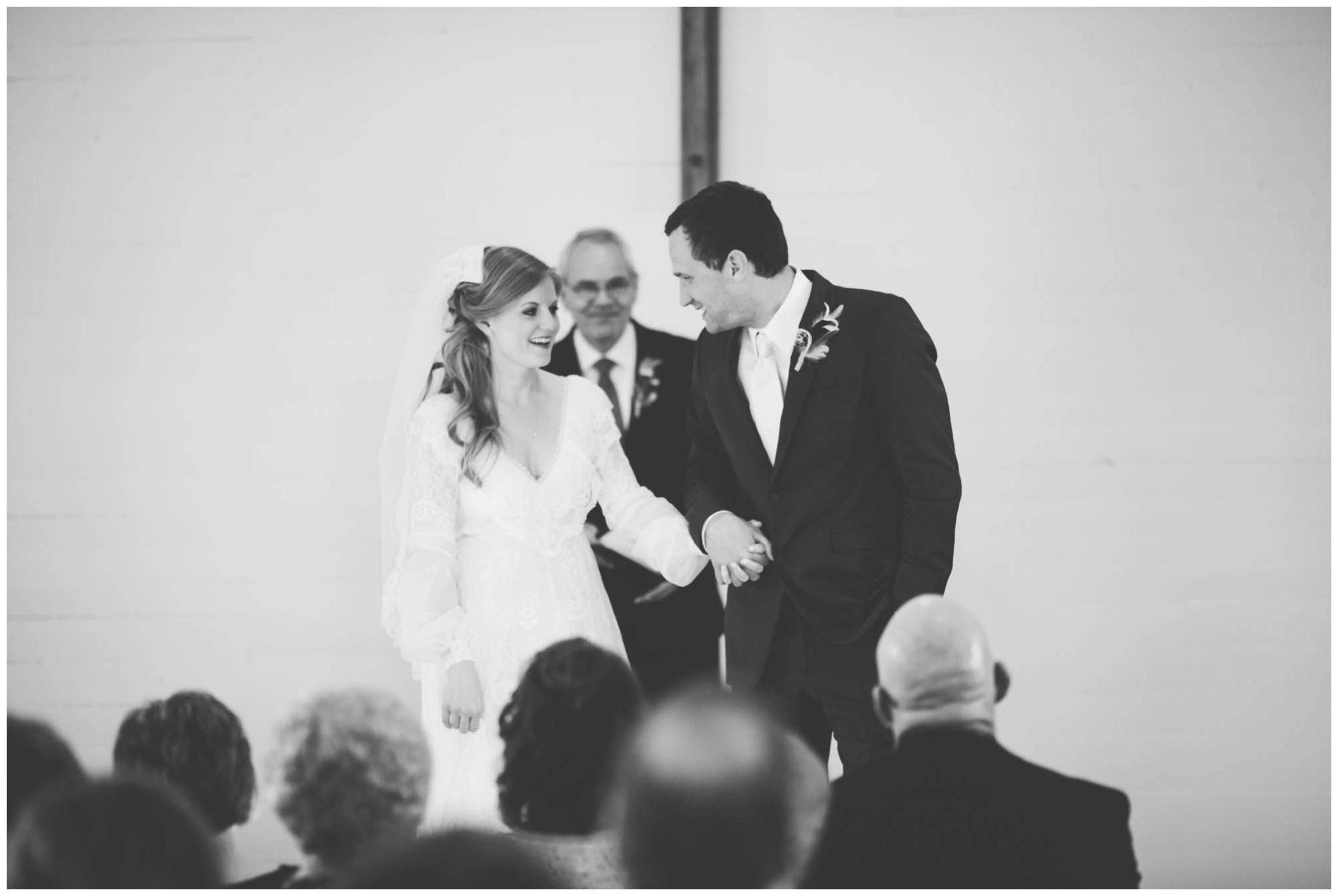 black and white photo of bride and groom recessional