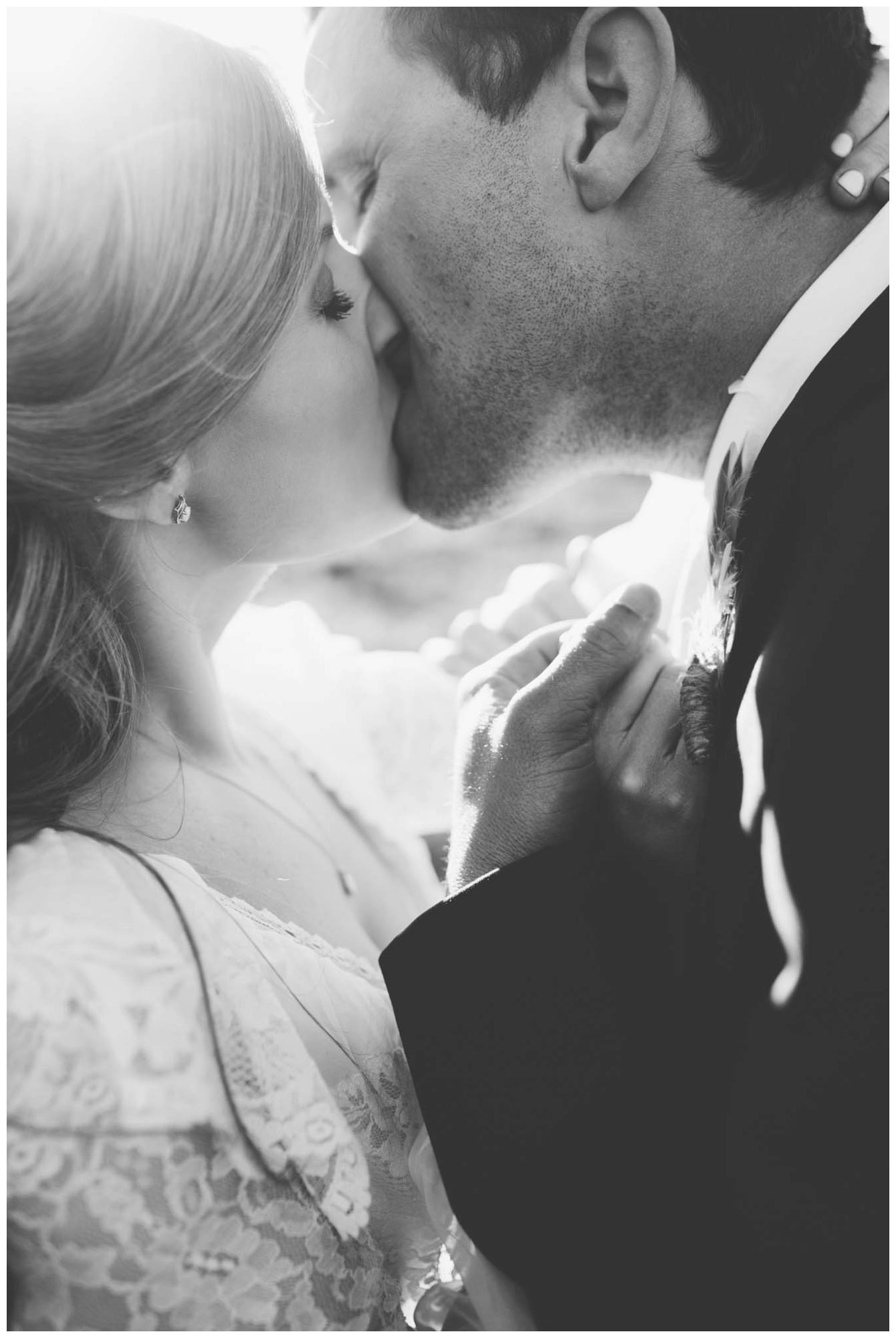 black and white couples photo of bride and groom kissing