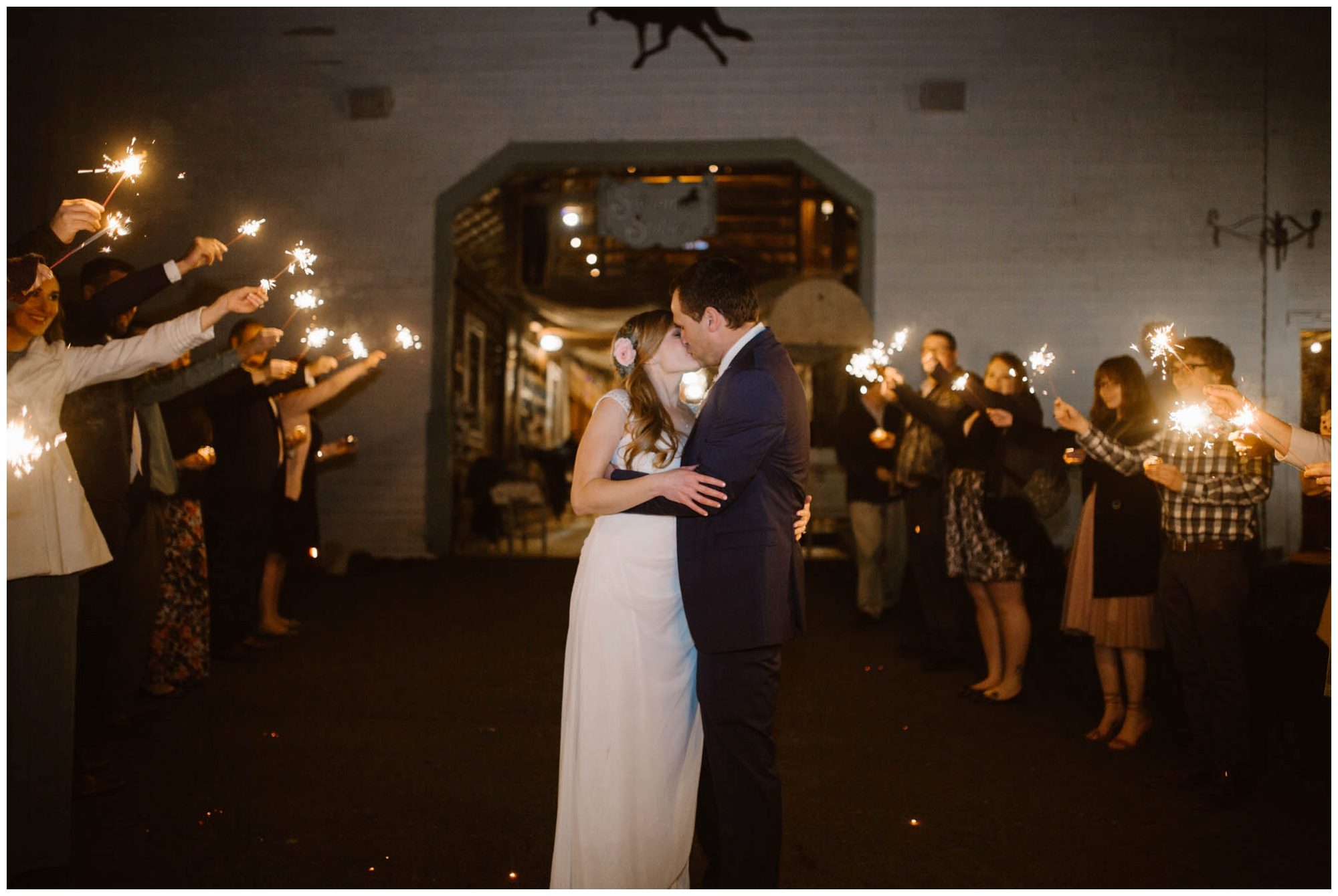 bride and groom kissing at sparkler exit wedding