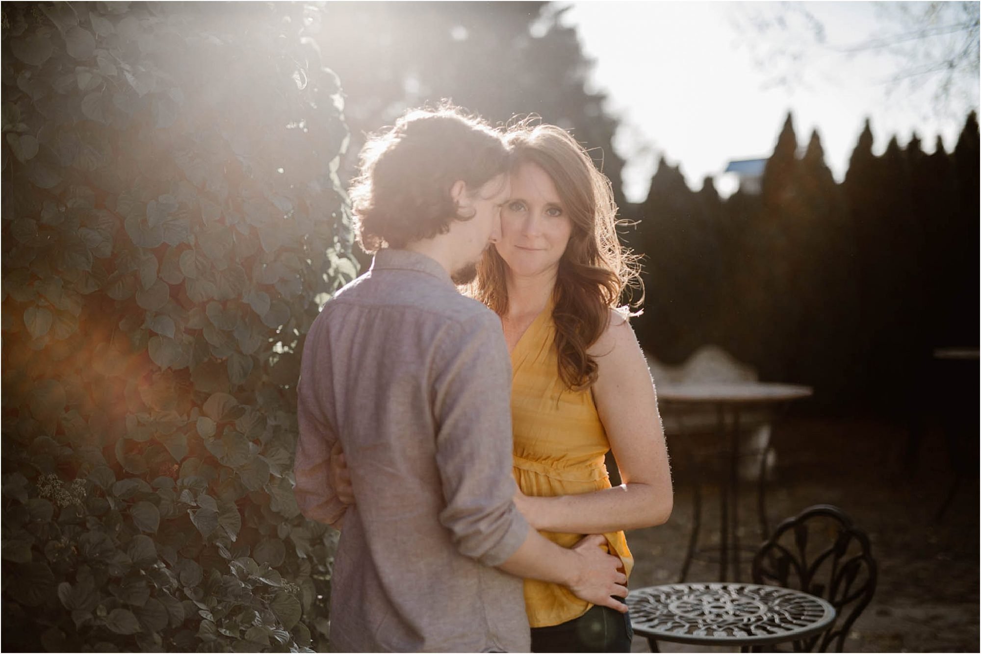 sunflare photo of girl and boy hugging at engagement session