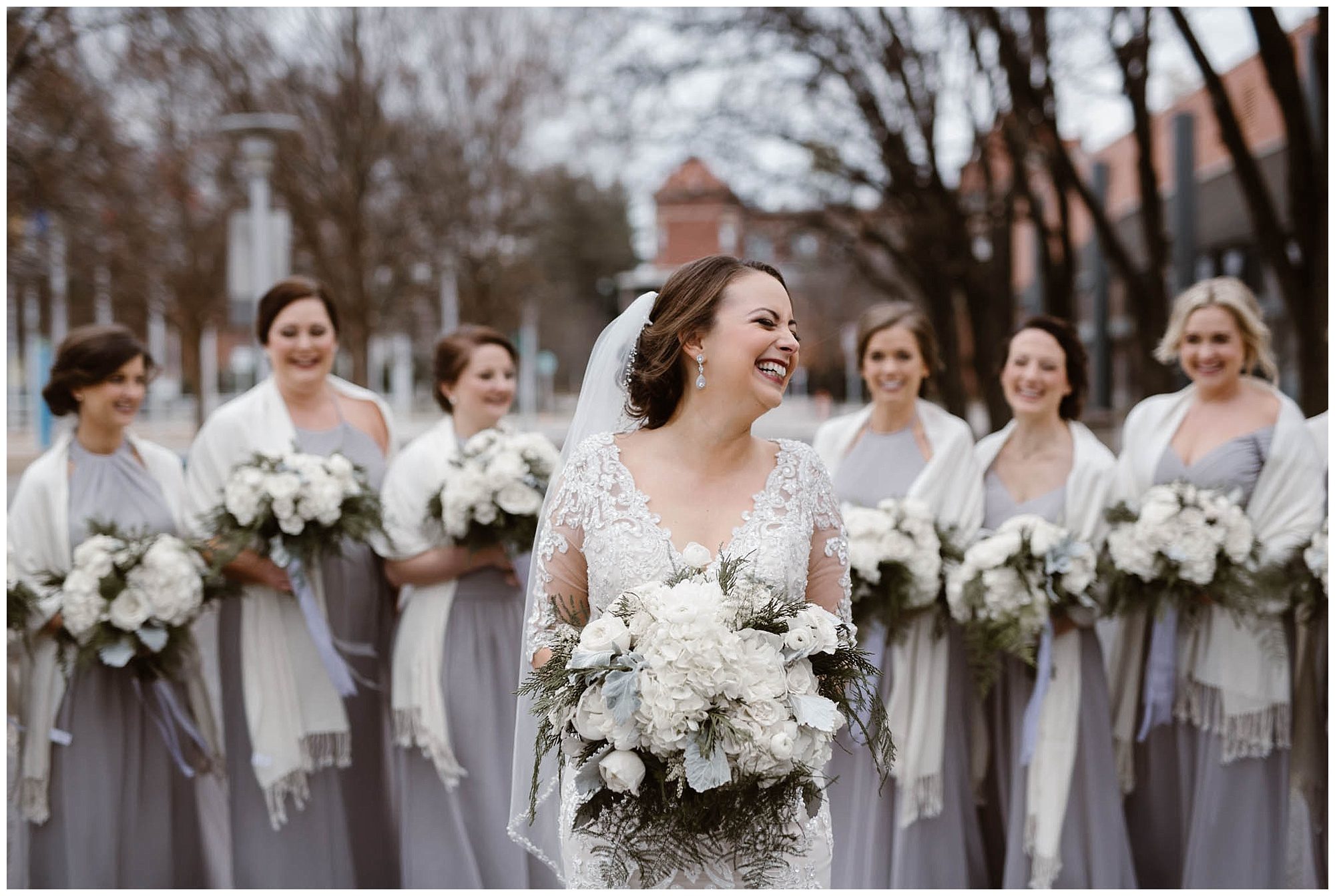 bride laughing with bridesmaids in the background