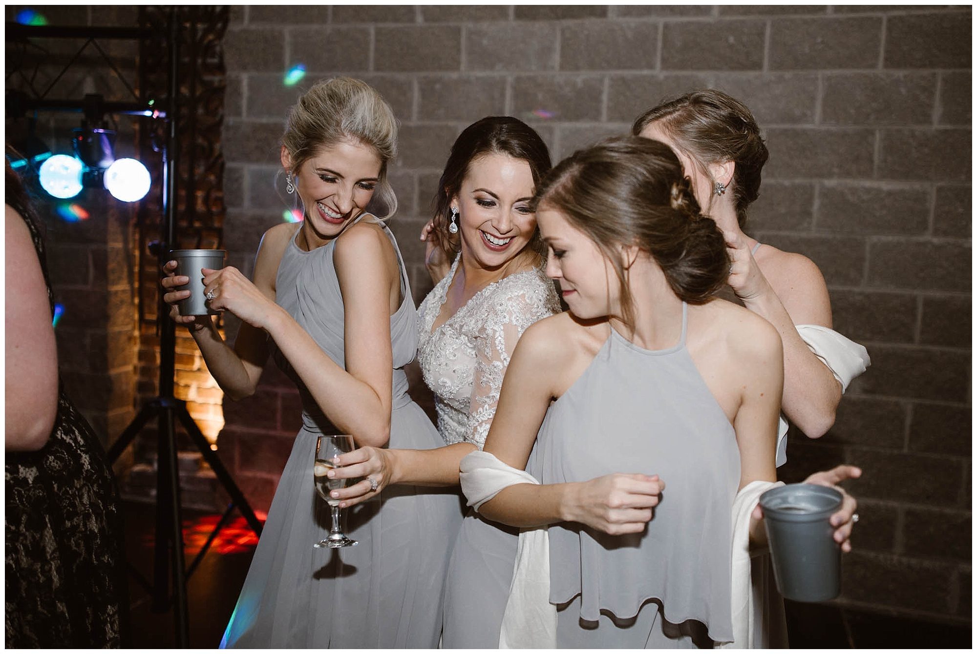 bride dancing with bridesmaids at wedding reception