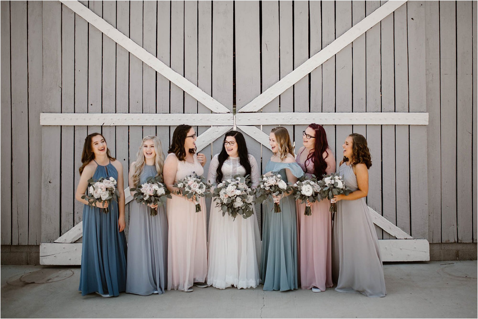 bridal party photos in front of barn doors