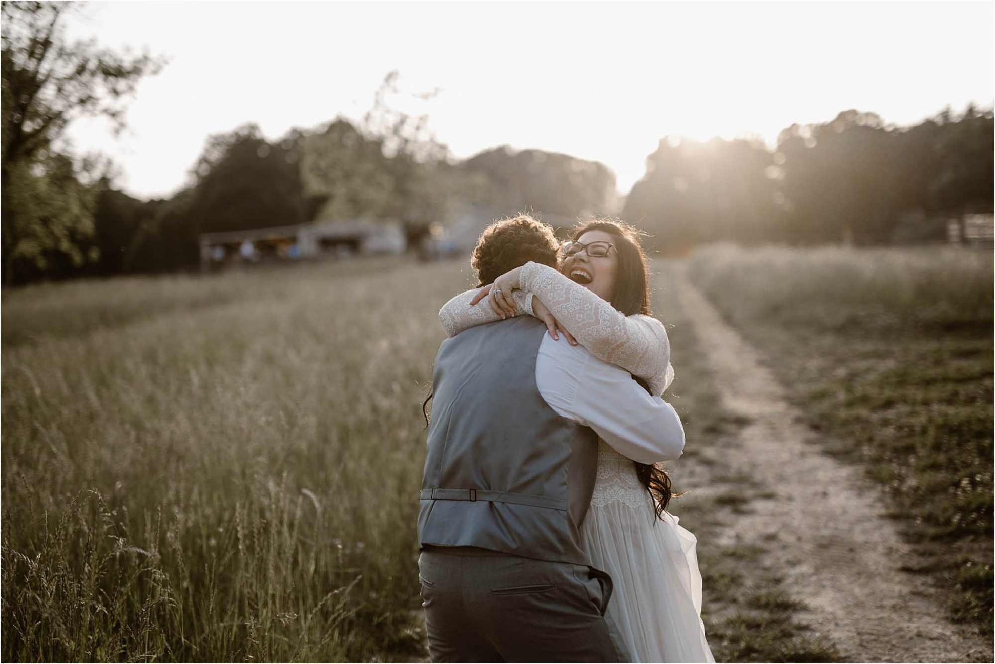 man and woman embracing in field during sunset