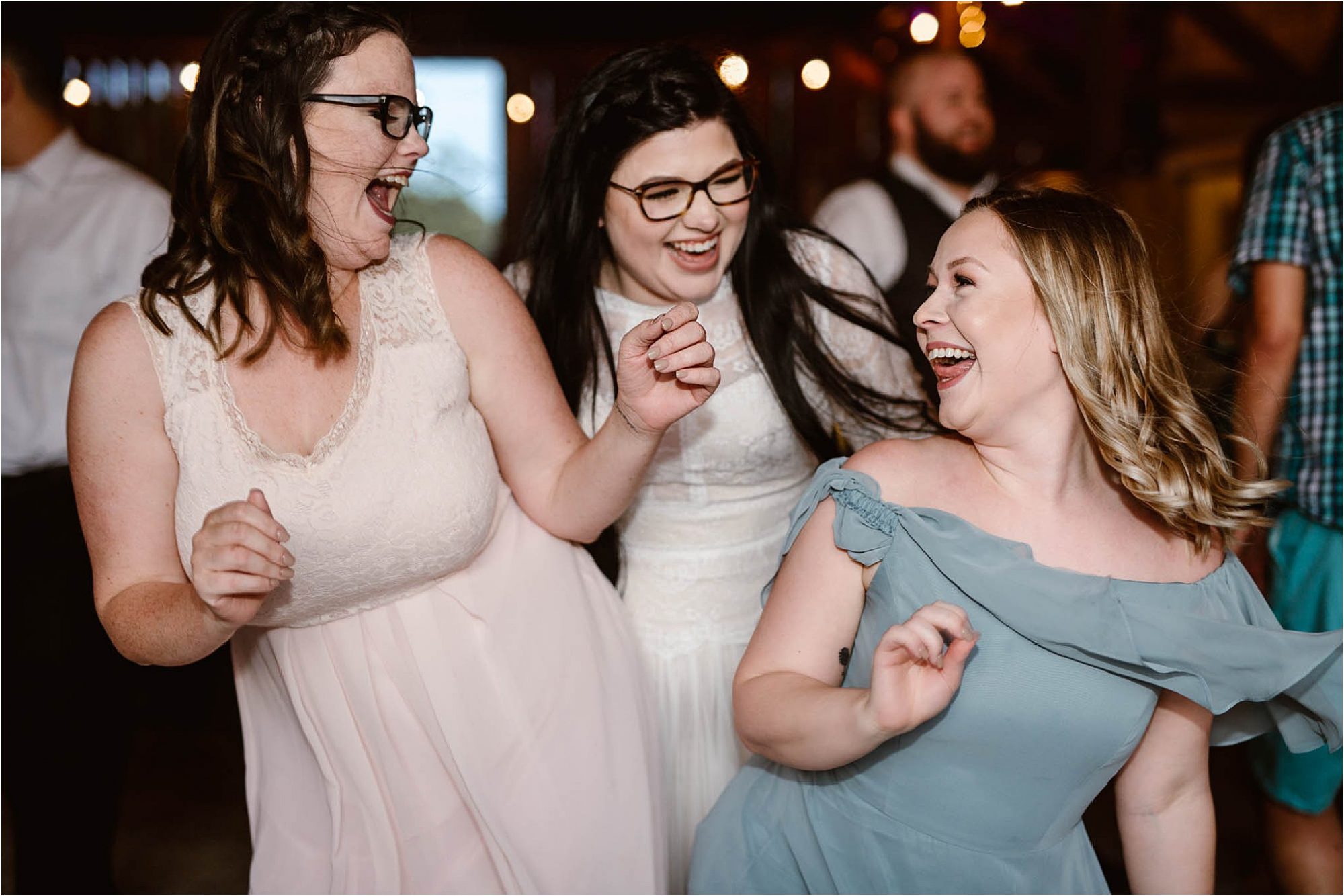 bride dancing with bridemaids at wedding