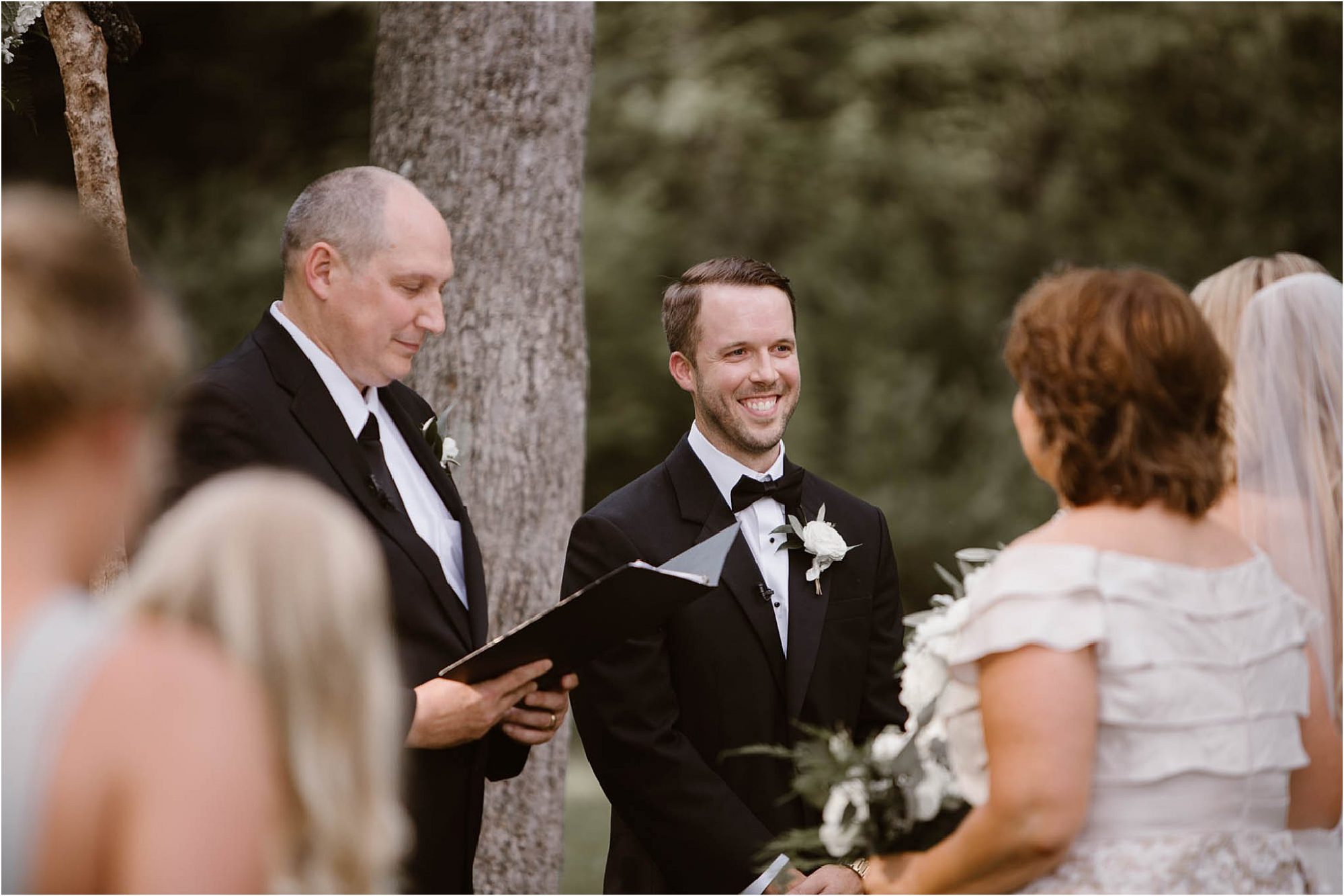 groom smiling at altar on wedding day