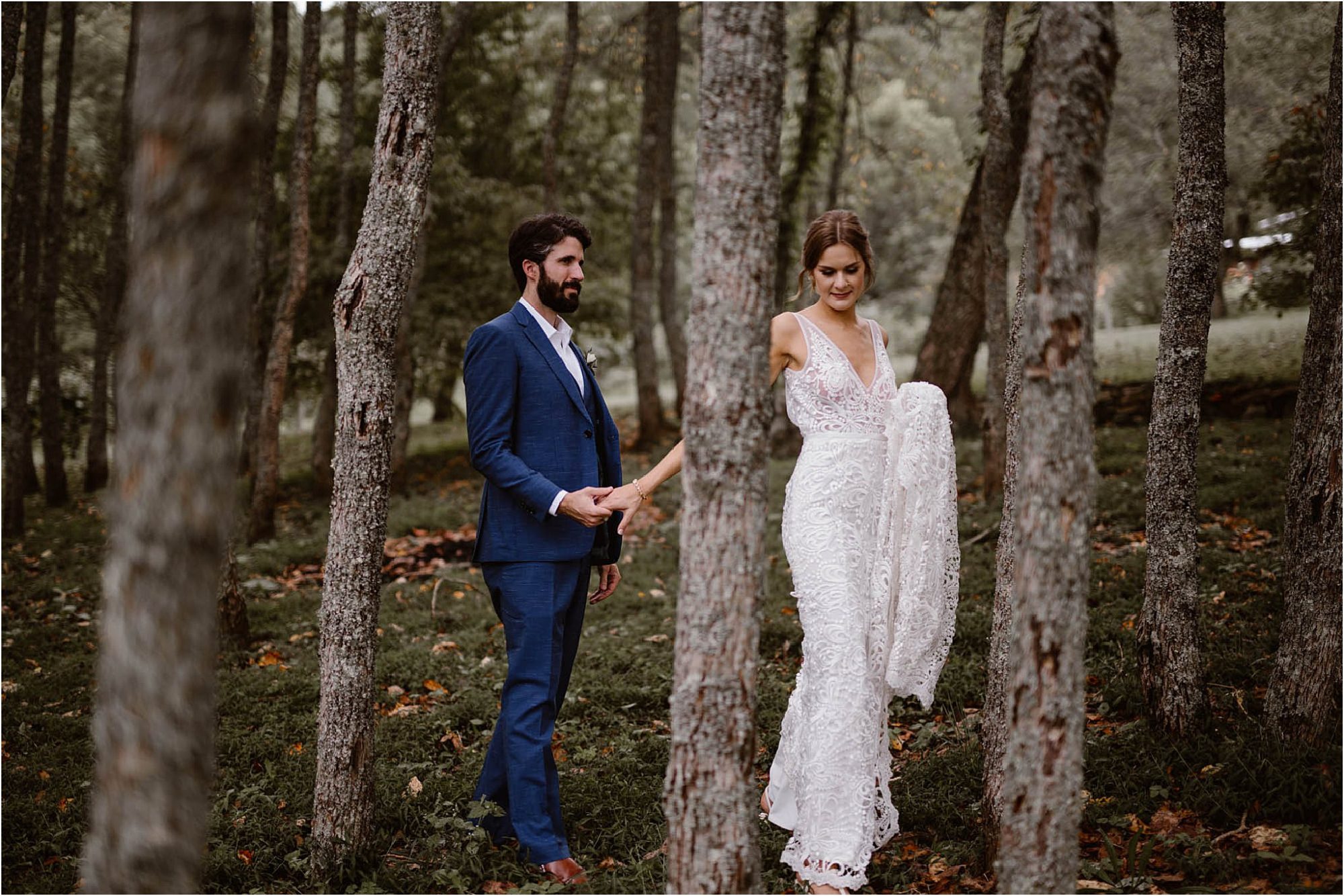 bride and groom walking through forest at North Carolina Vineyard