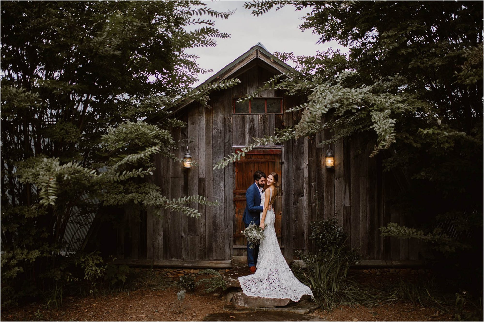bride and groom standing in front of groom's cabin at The Vineyards at Betty's Creek