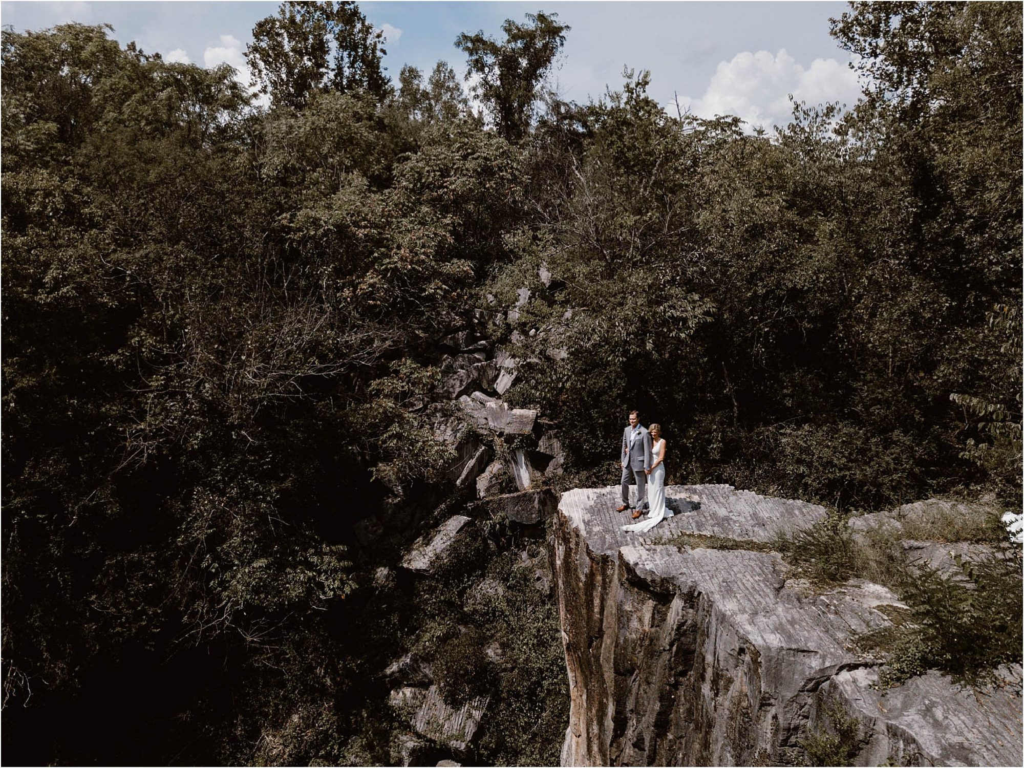 drone photos of bride and groom on cliff