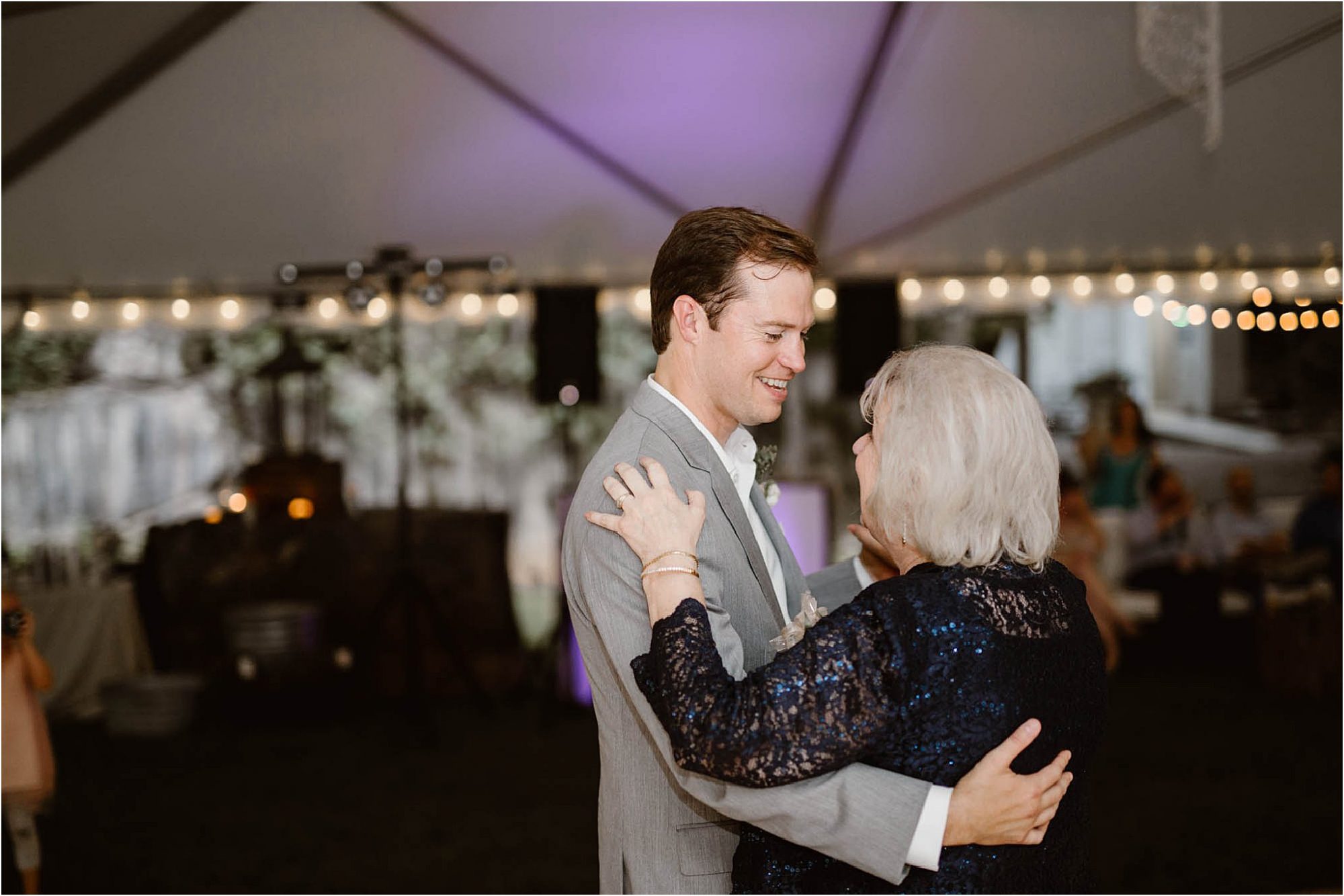 groom and mother first dance under tent