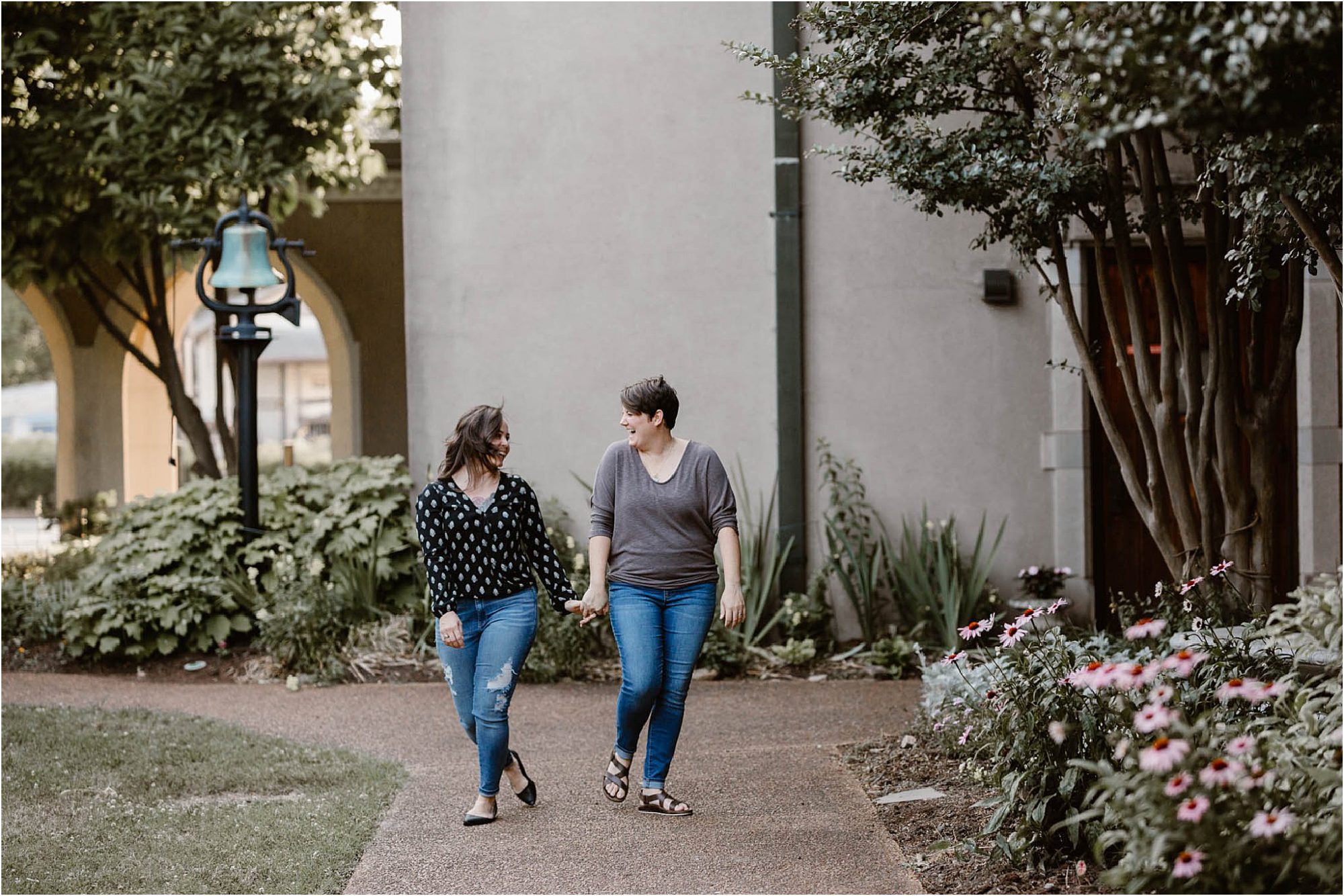two women laughing in church courtyard