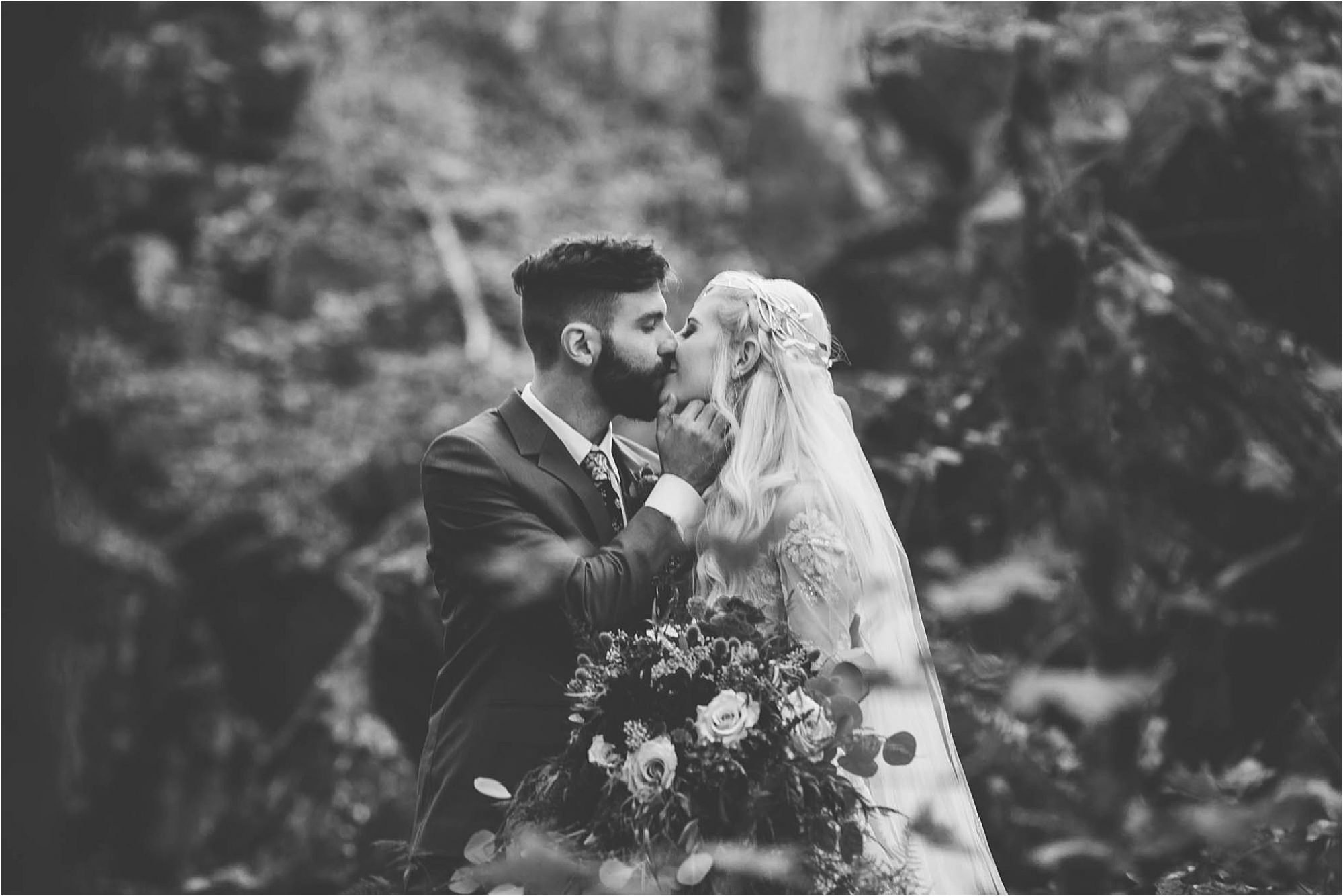 groom kissing bride on quarry rocks