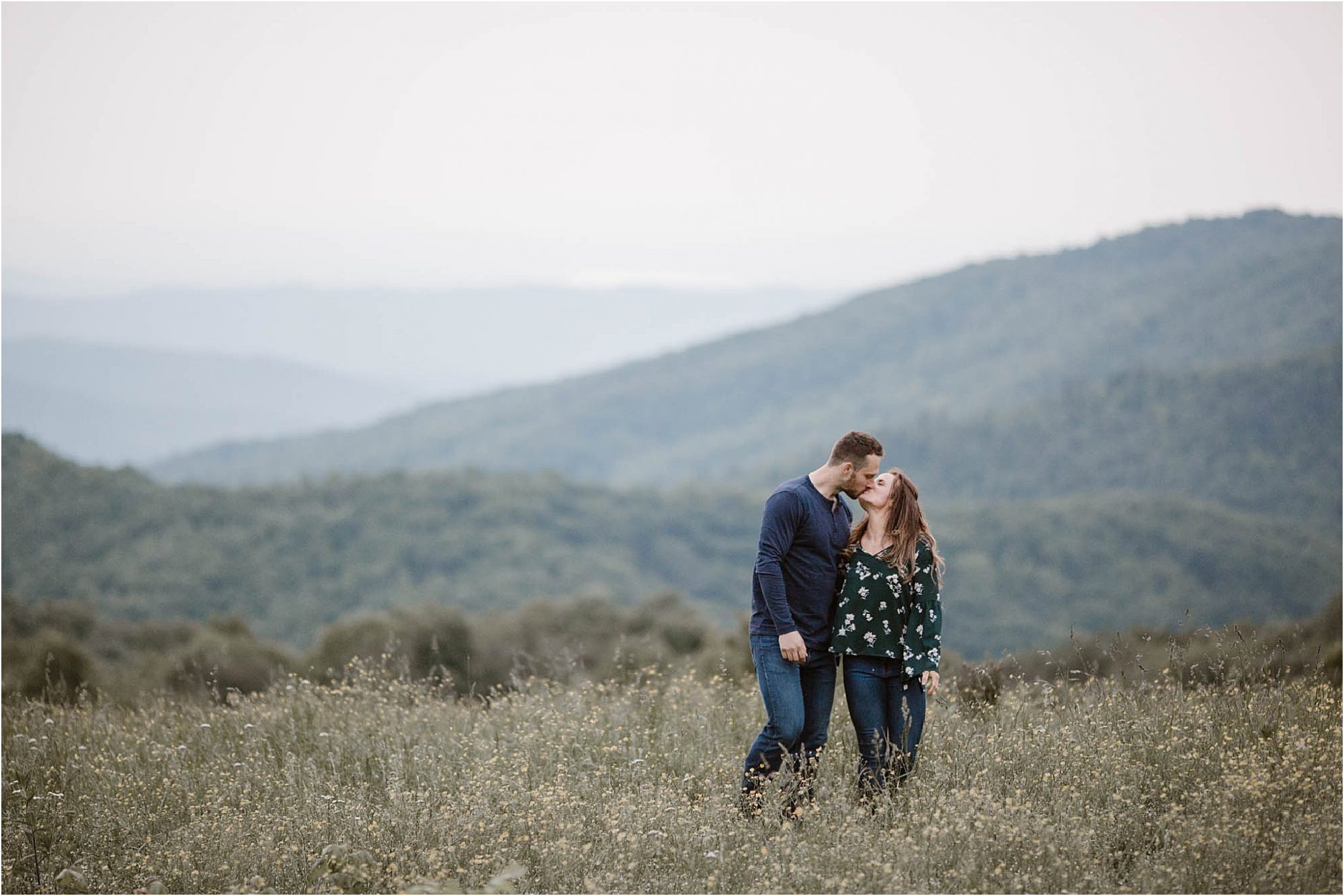 man and woman kissing in field on Max Patch Mountain