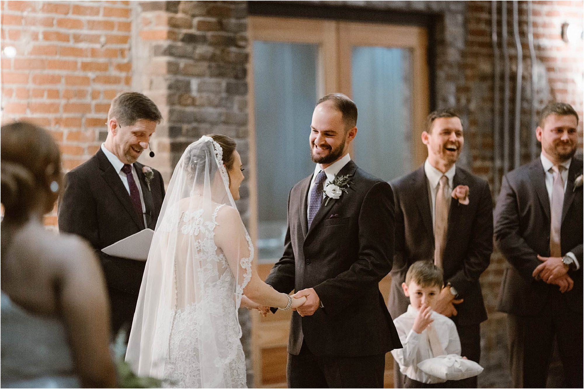 groom laughing during ceremony on wedding day