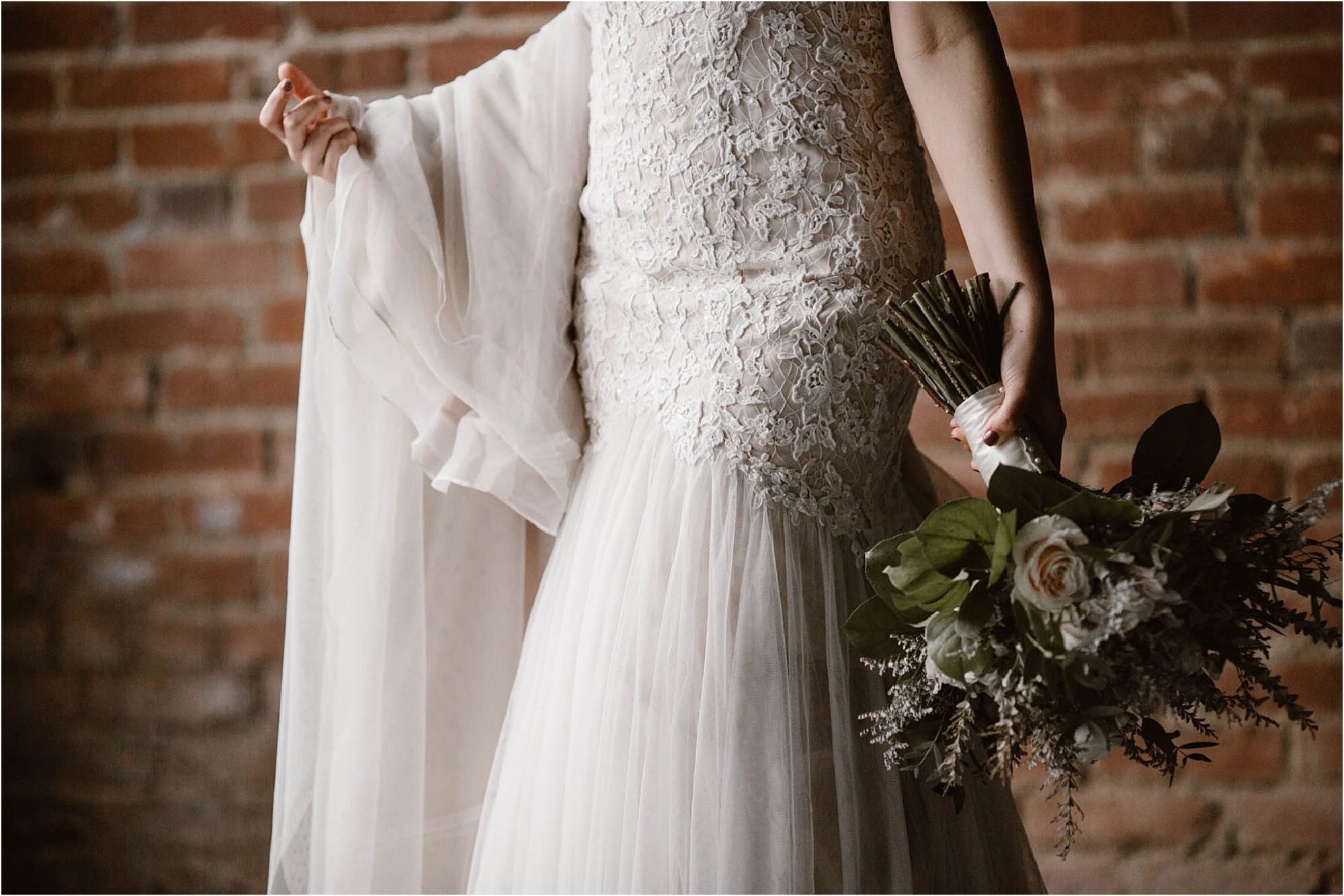 bride holding dress and wedding bouquet
