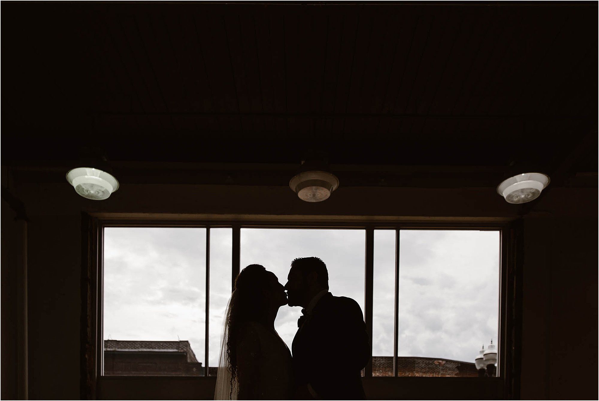 silhouette kiss of a bride and groom