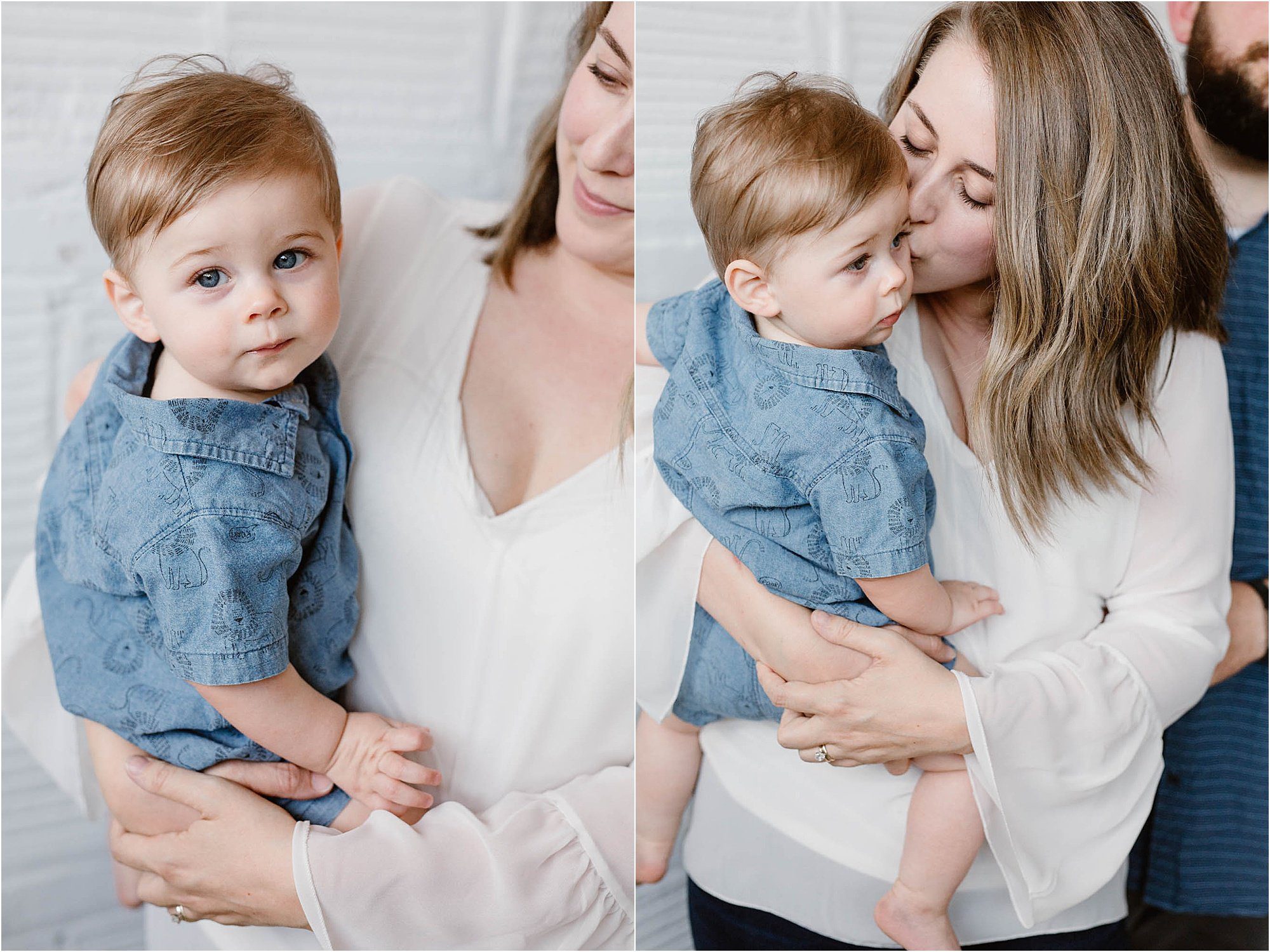 small child in blue jean romper being held by woman in white