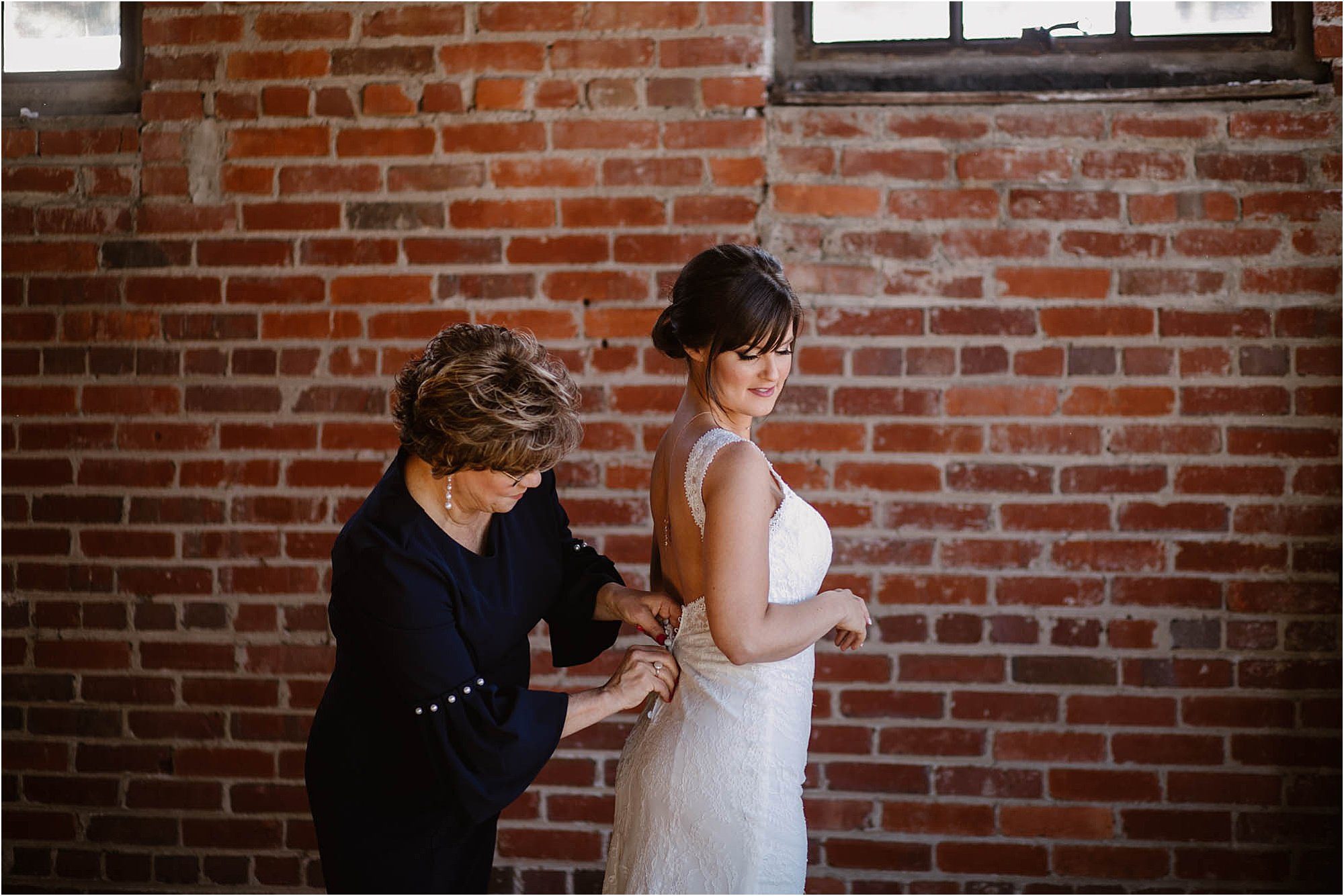 bride and mother getting ready on wedding day