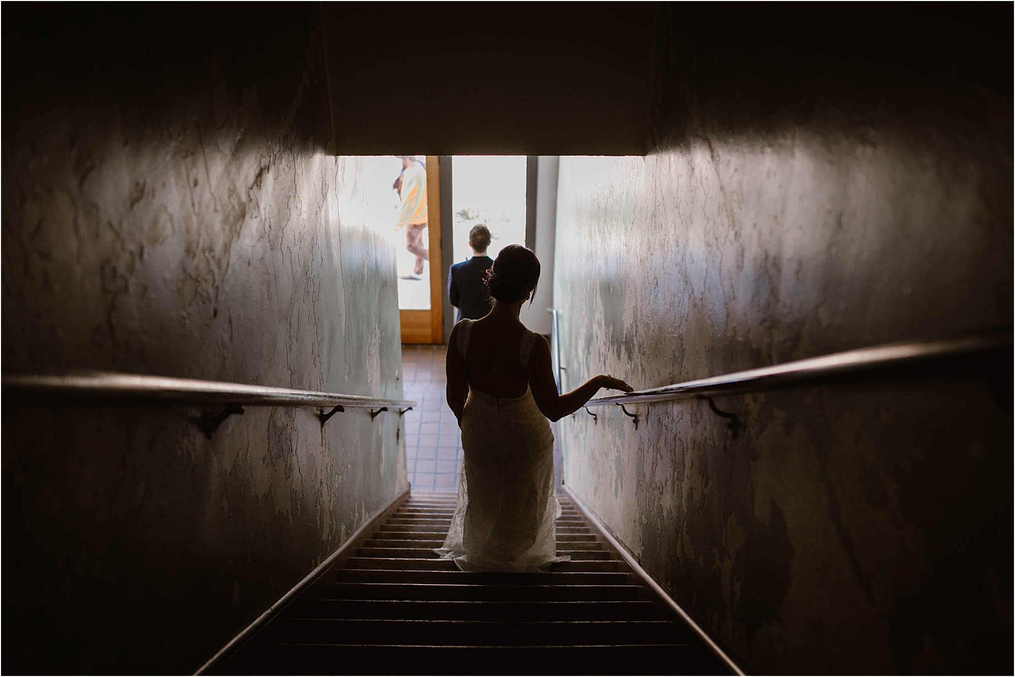 bride walking down stairs to groom