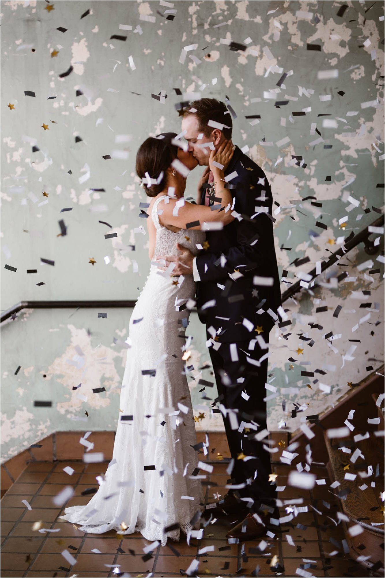 bride and groom kissing in confetti