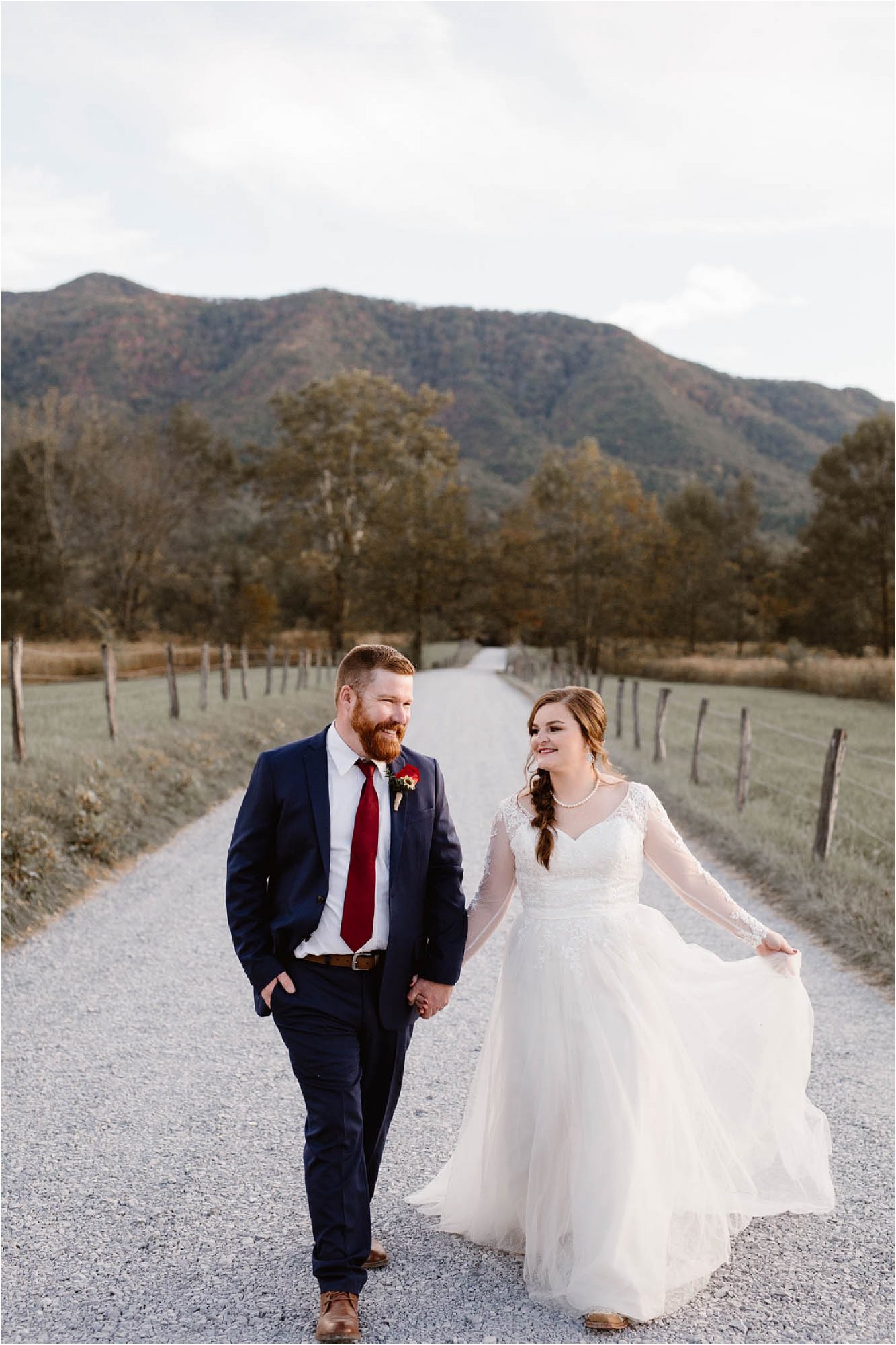 bride and groom walking along gravel road in the Smokies