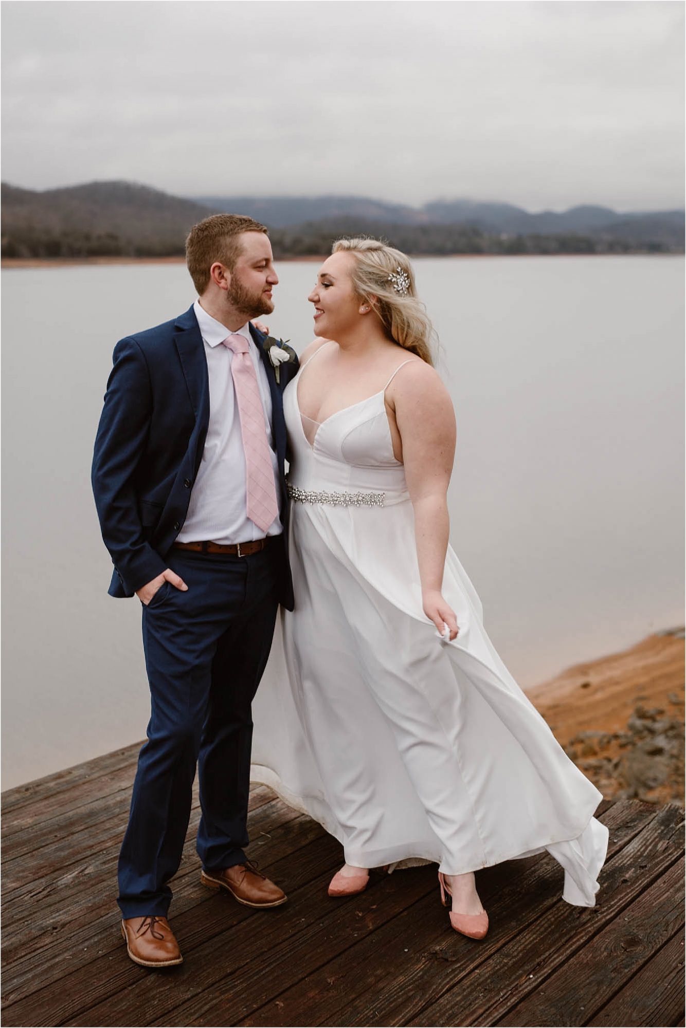 bride and groom standing on dock at wedding elopement