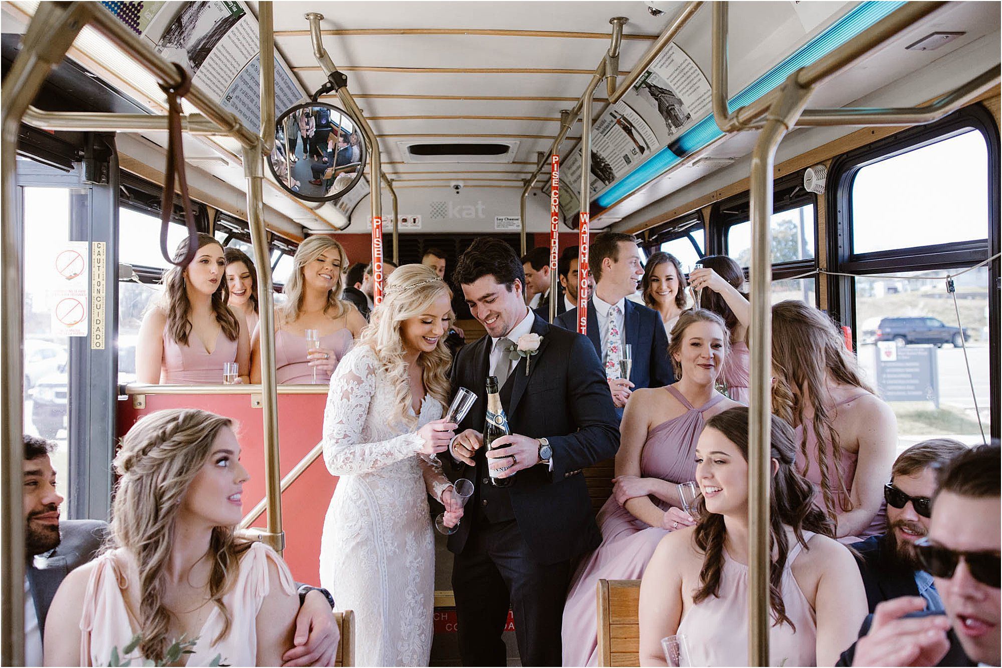 bride and groom popping champagne on trolley