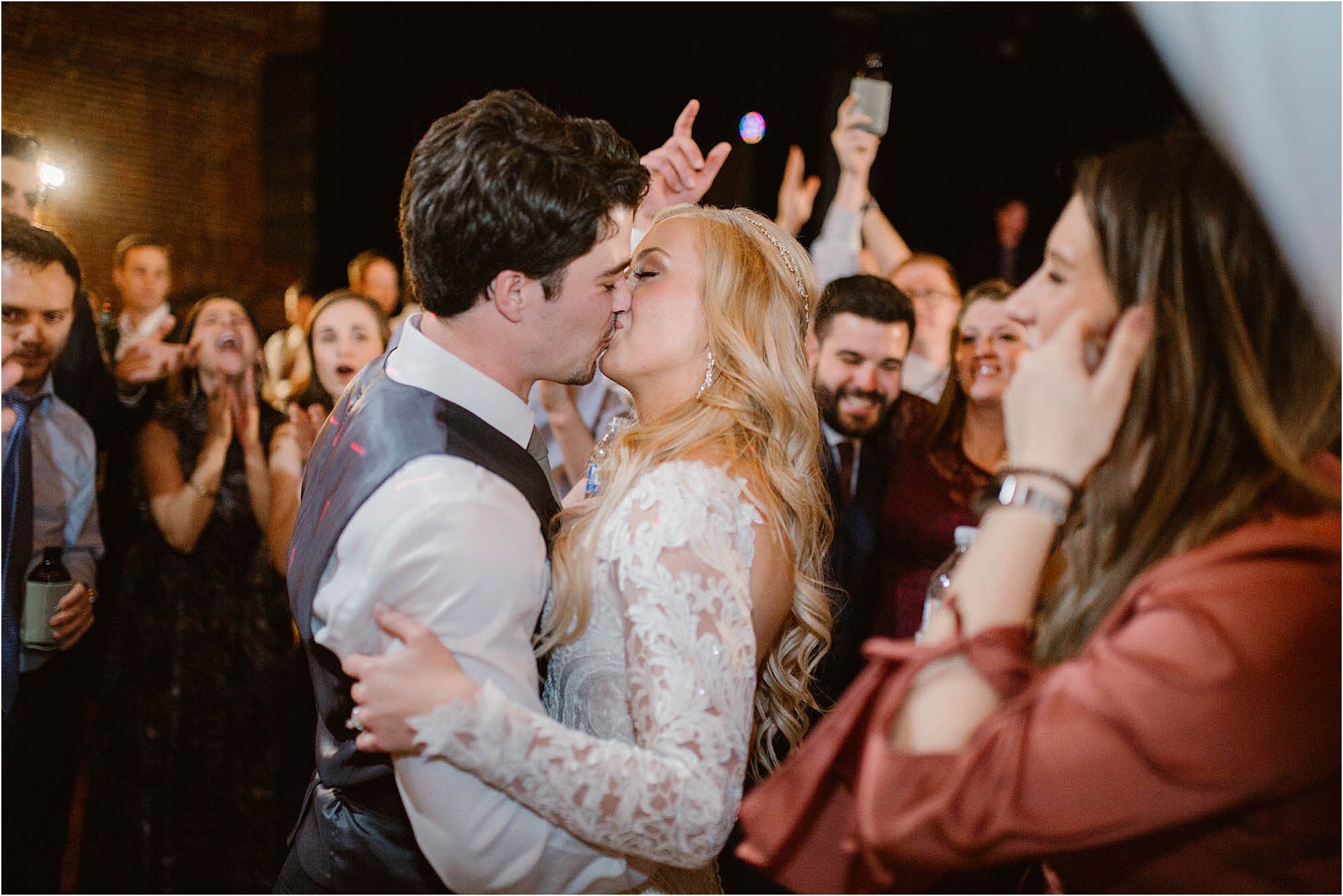 bride and groom kissing on dance floor