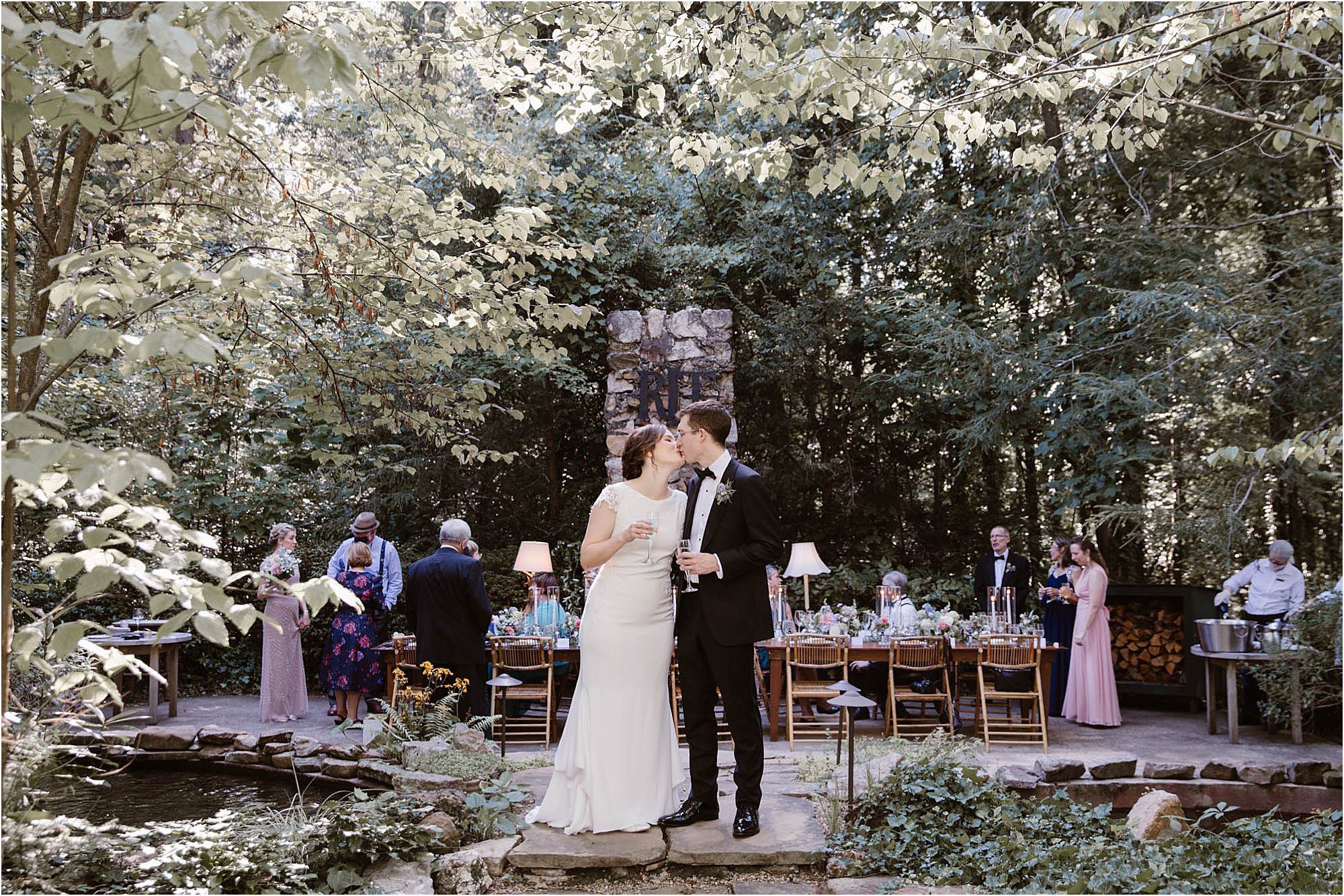 bride and groom kissing at outdoor fireplace