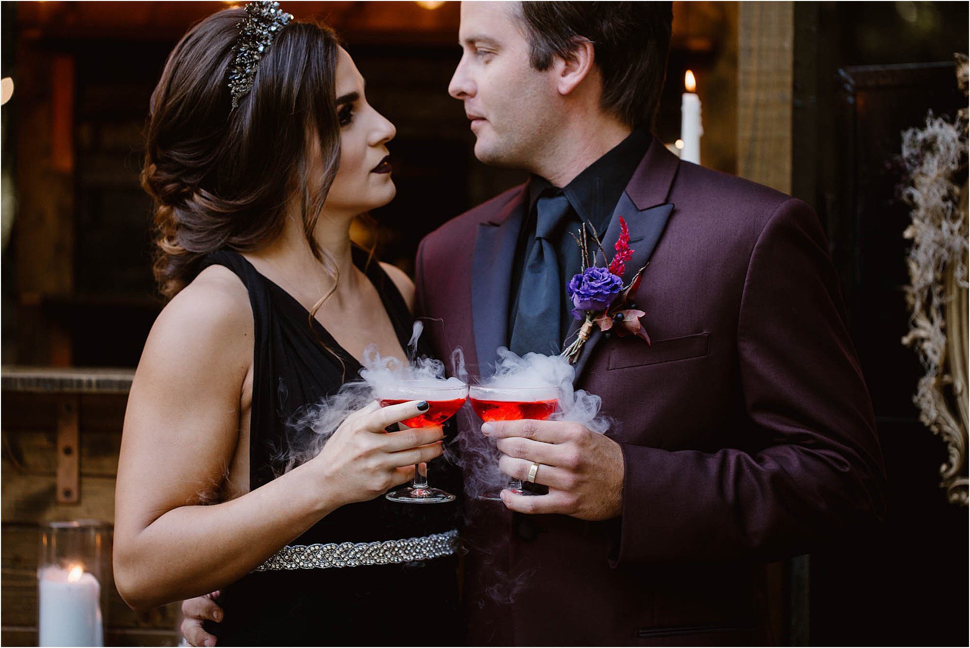 bride and groom holding drinks with dry ice