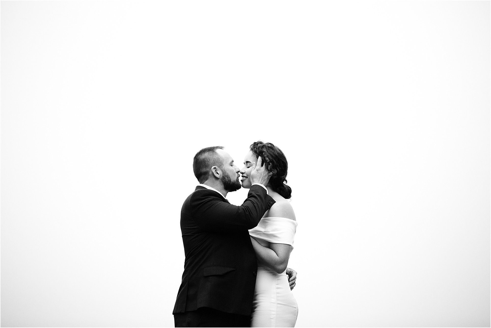 black and white photos of bride and groom kissing
