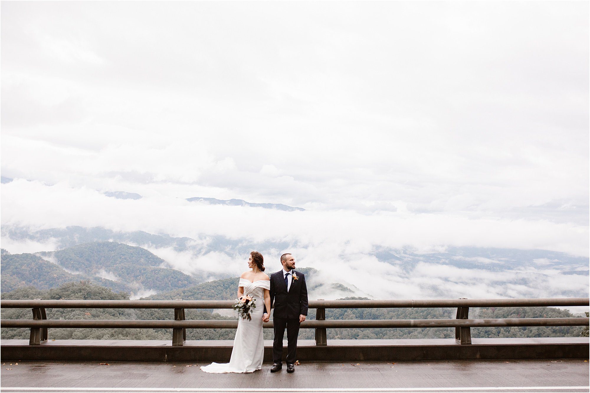 bride and groom stand along bridge in the Smokies
