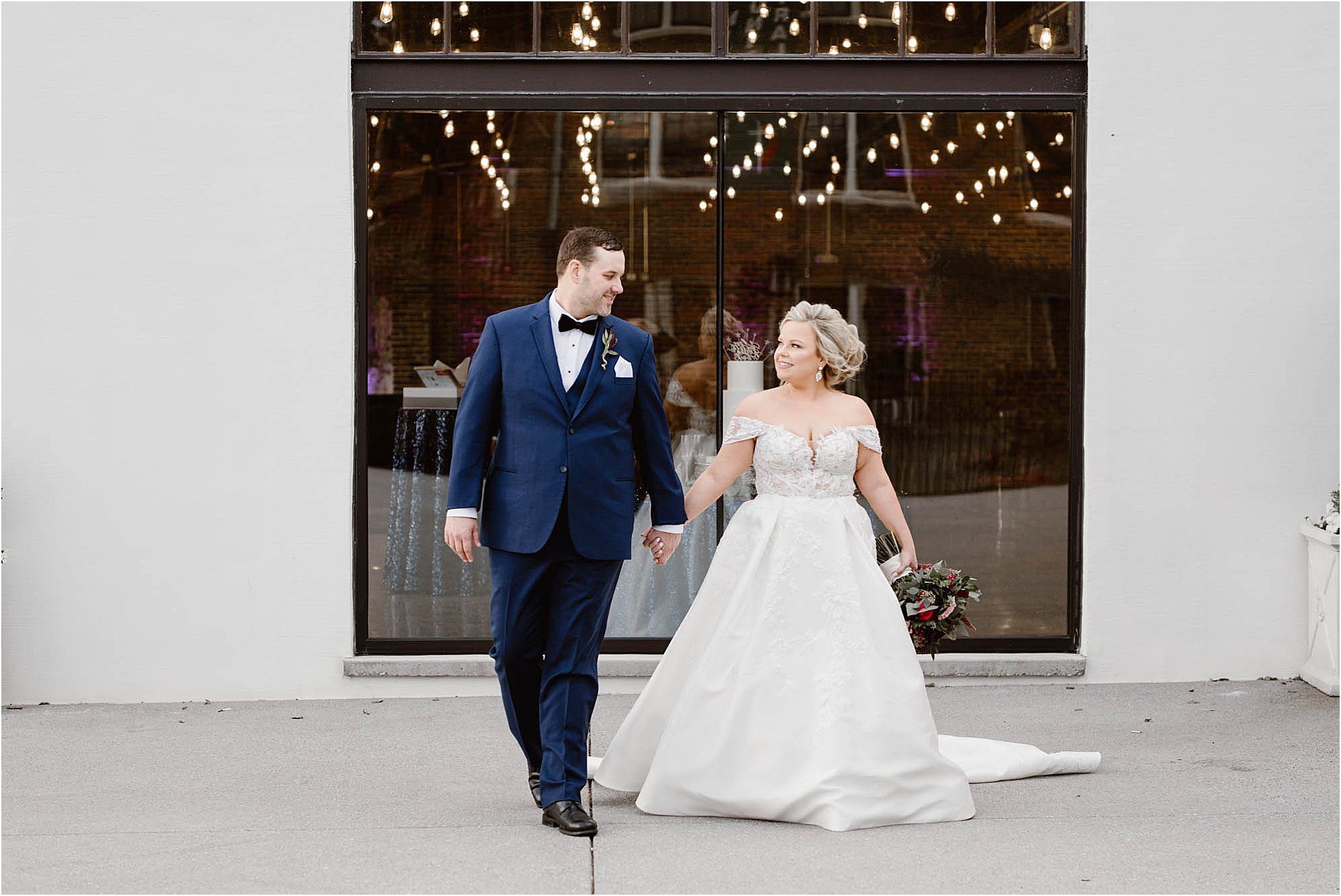 bride and groom walk outside white venue in Knoxville