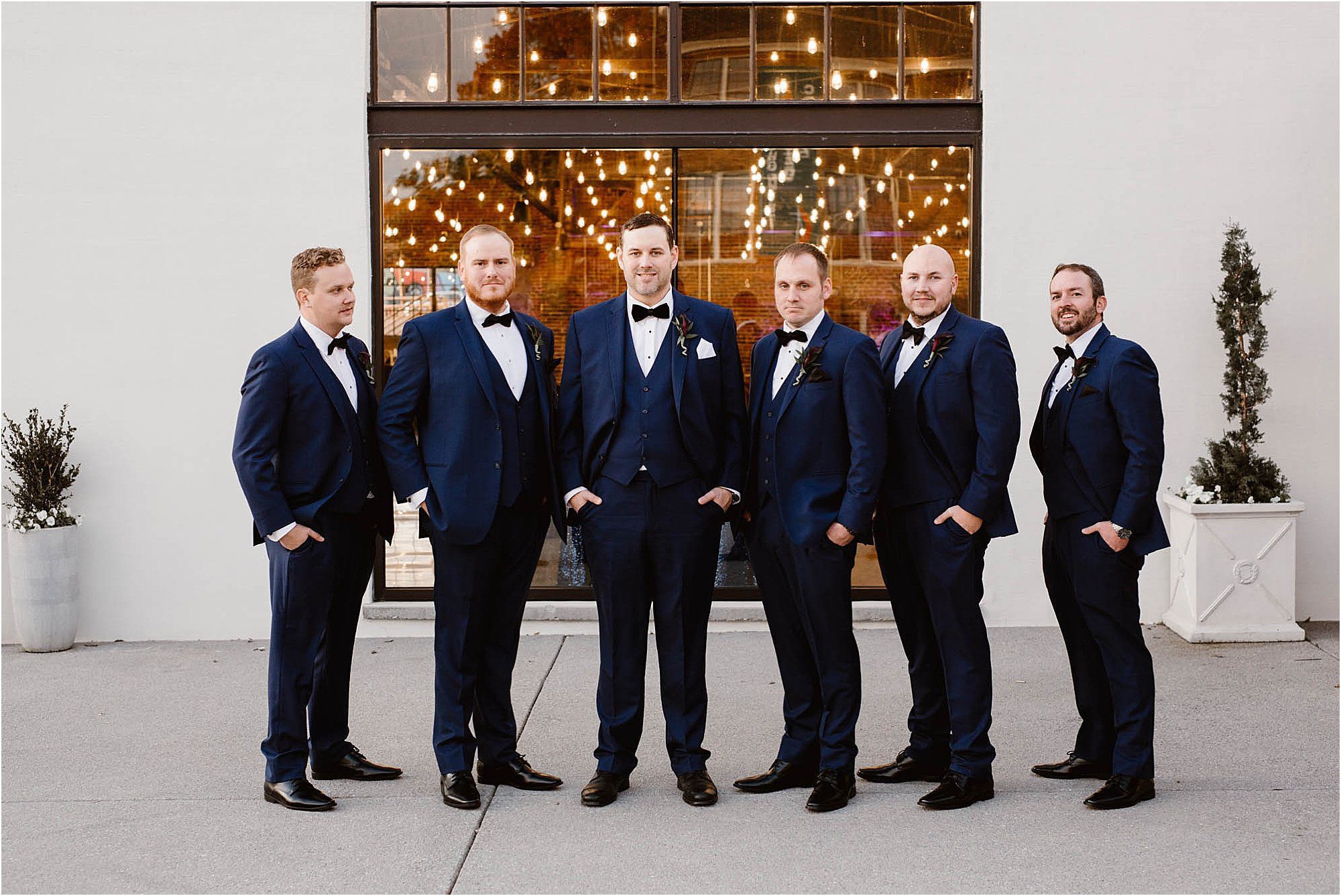groom and groomsmen in navy and black suits
