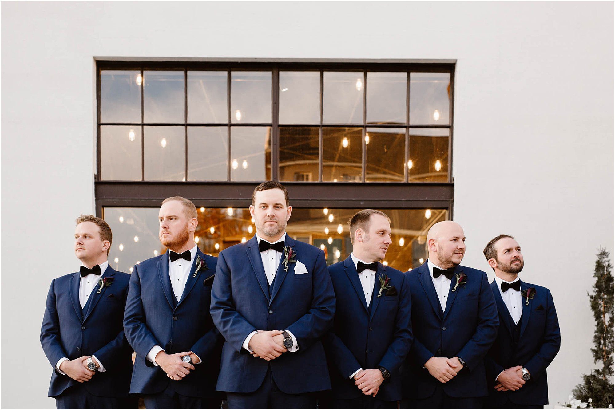 groom and groomsmen in navy and black suits